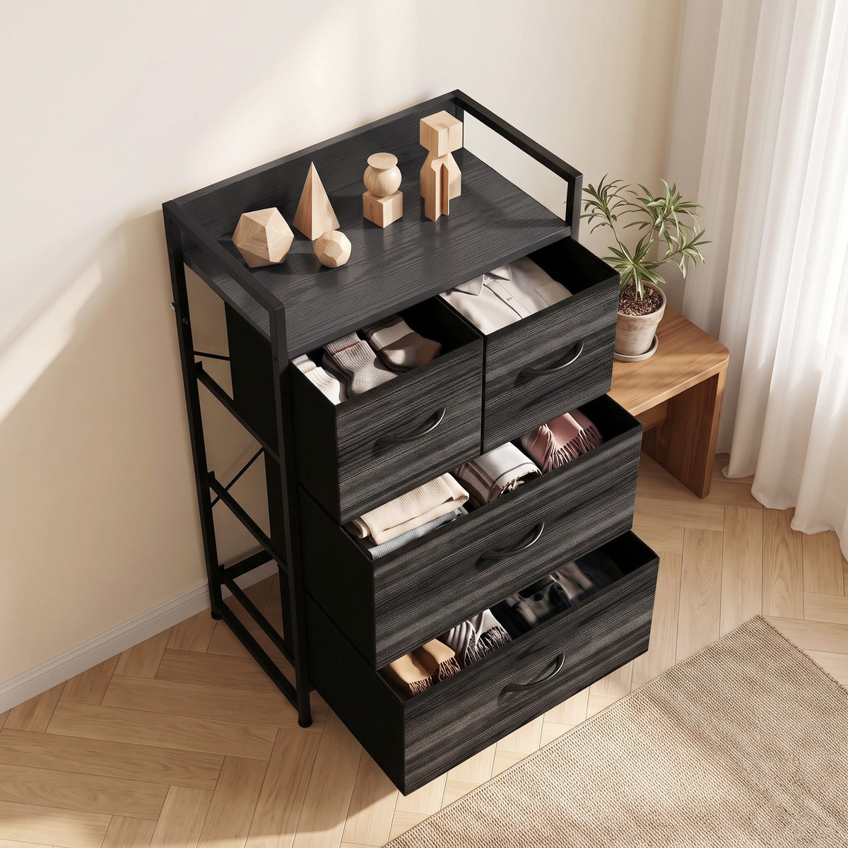 Black drawer cabinet with four fabric drawers open and top shelf displaying items