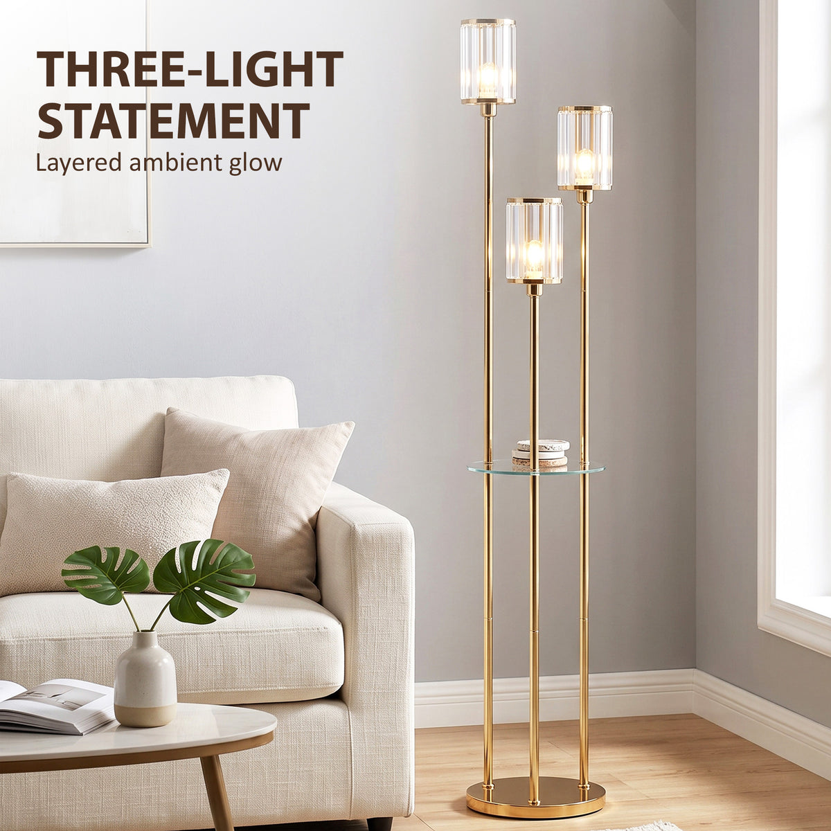 Gold three-light floor lamp with tall stand and round glass shelf, clear crystal-like glass shades