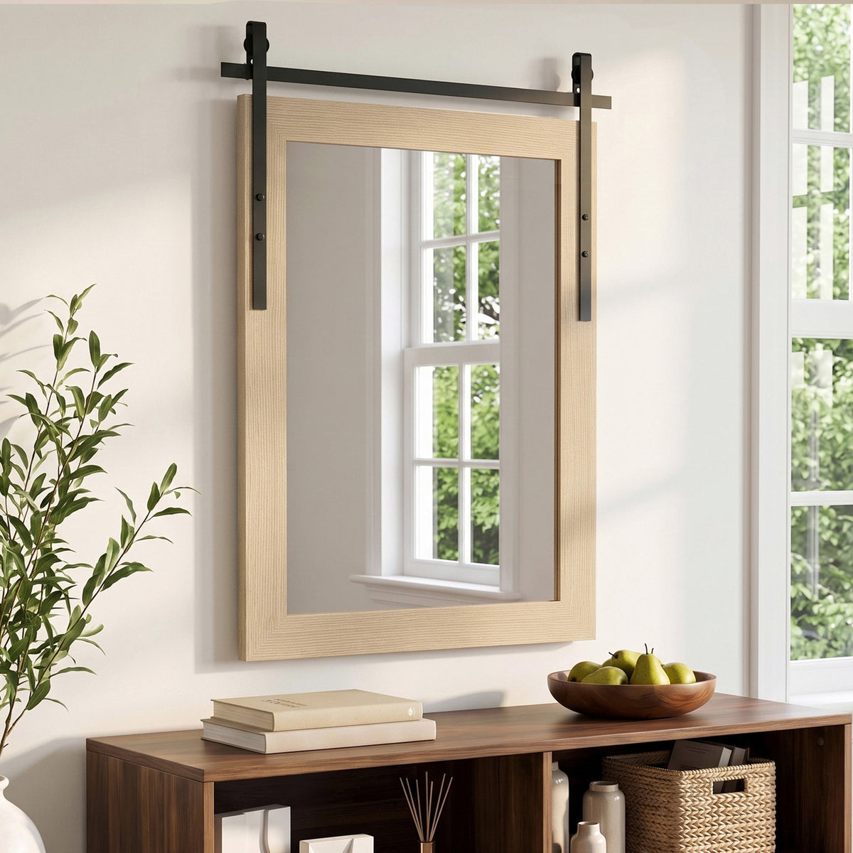 Rectangular wall mirror with light oak frame above console table with black mounting brackets