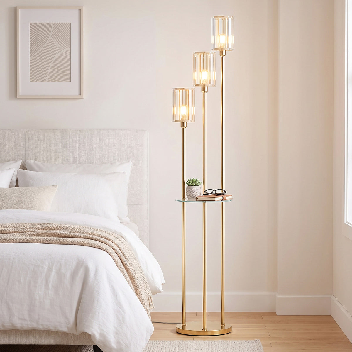 Gold floor lamp with three clear crystal-like glass shades and round glass shelf