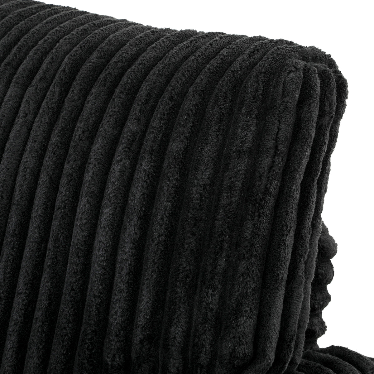 Black corduroy armrest close-up with thick vertical ribbed upholstery
