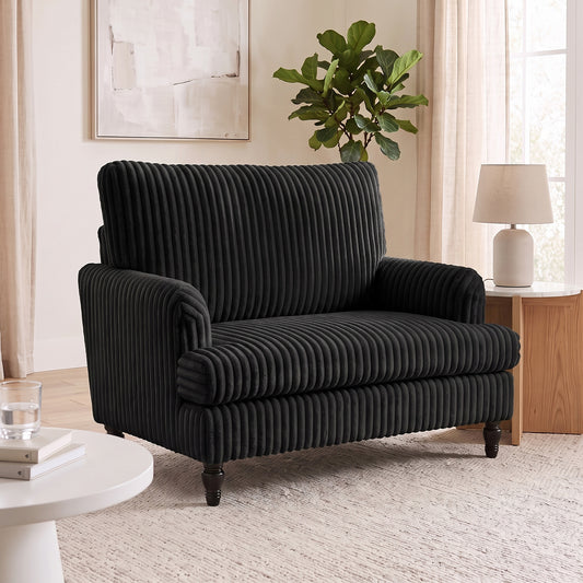 Black corduroy accent armchair with wide seat, rolled arms, ribbed texture