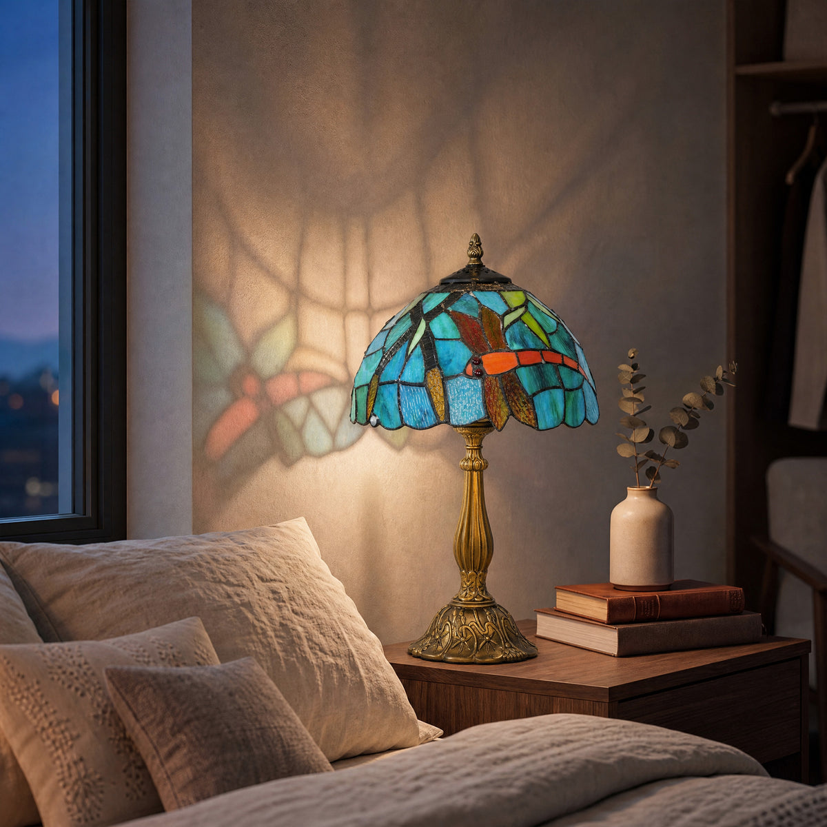 Tiffany-style stained glass table lamp with green-blue shade and brass base.
