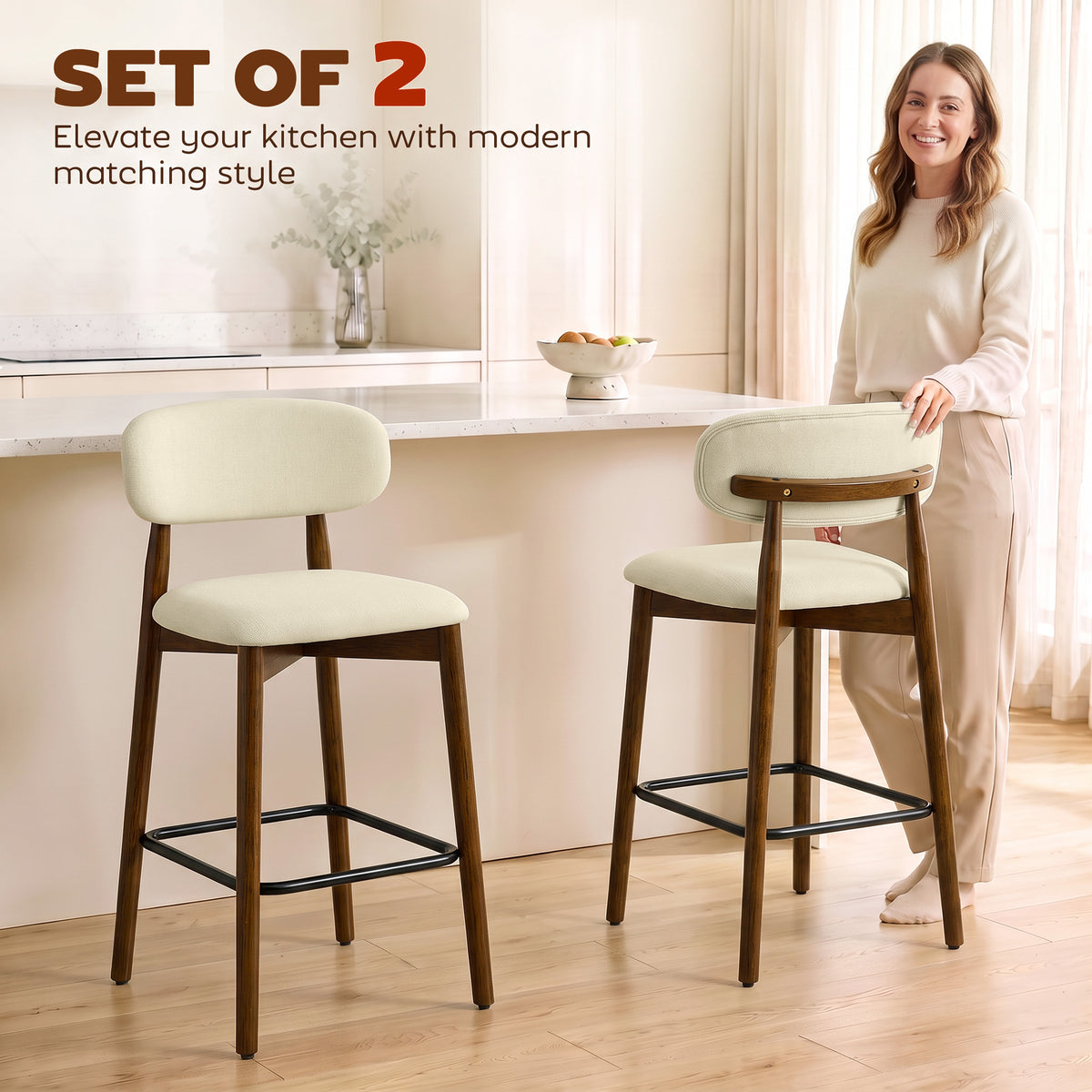 Set of 2 beige bar stools with curved backrests, wooden legs, and black footrests
