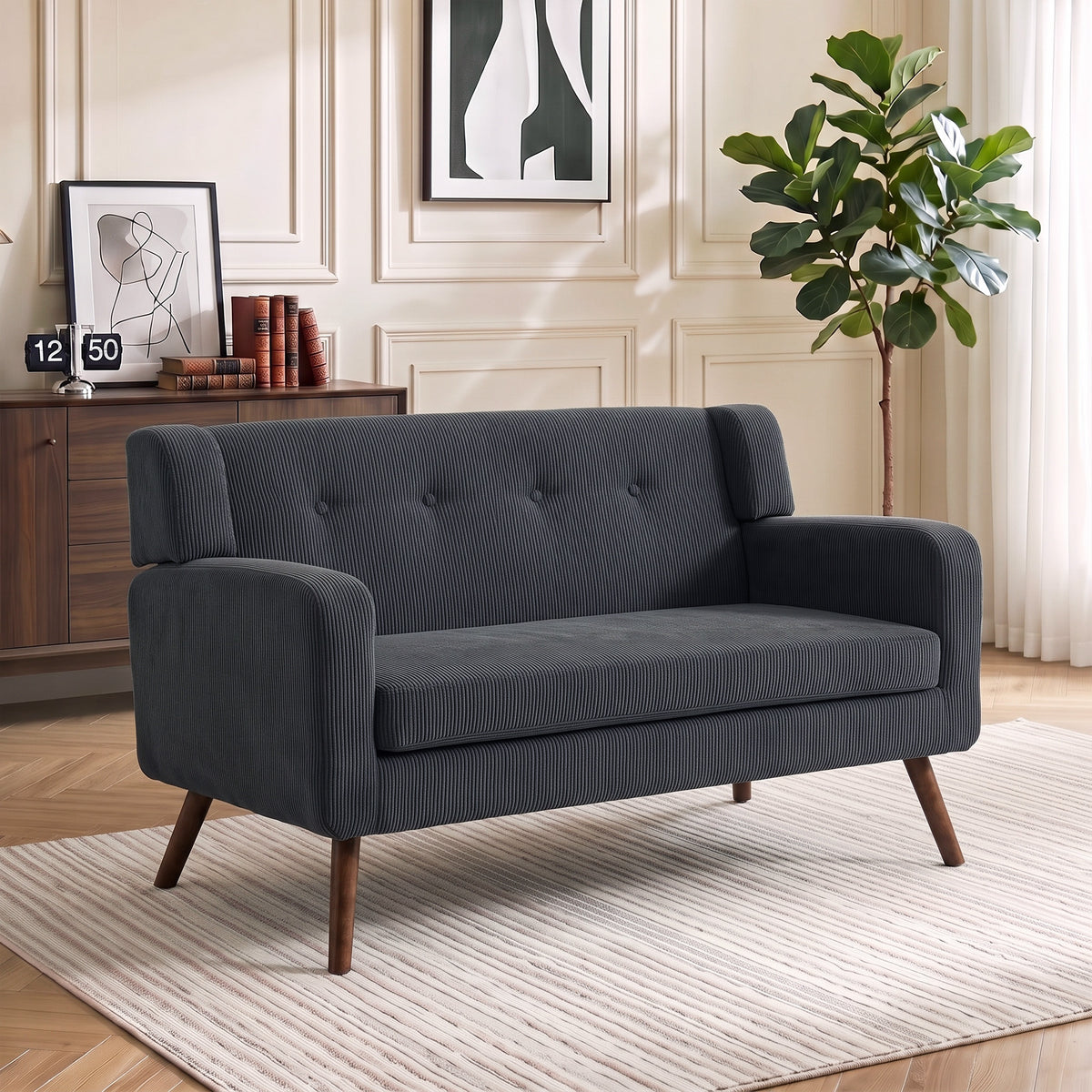 Gray corduroy loveseat with tufted back, rolled arms, and tapered wooden legs
