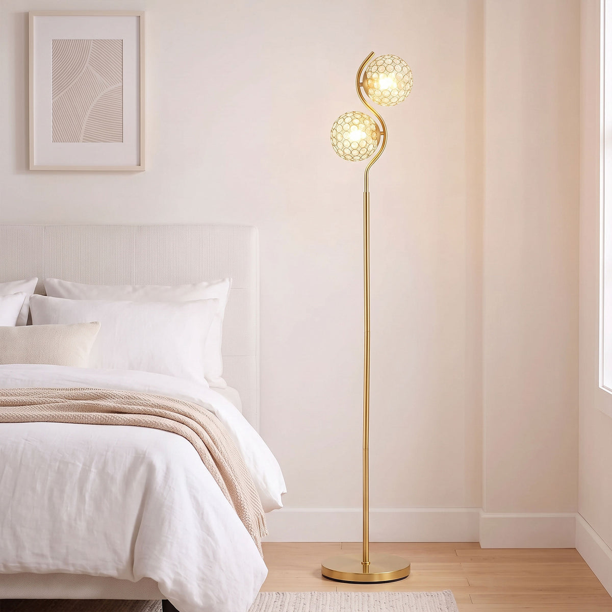Dual head floor lamp with two globe shades on tall gold stand and circular base
