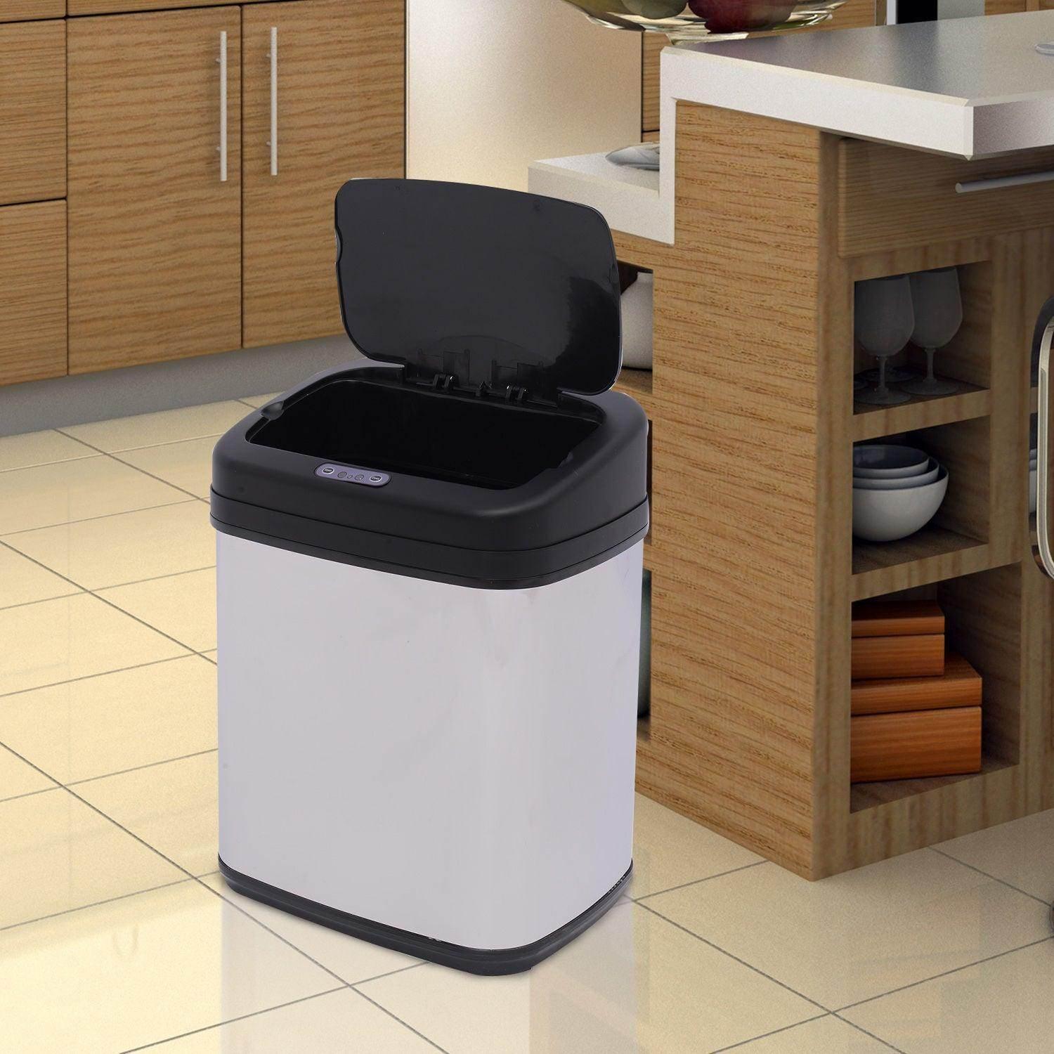 Automatic sensor trash bin with black lid and white body in modern kitchen setting