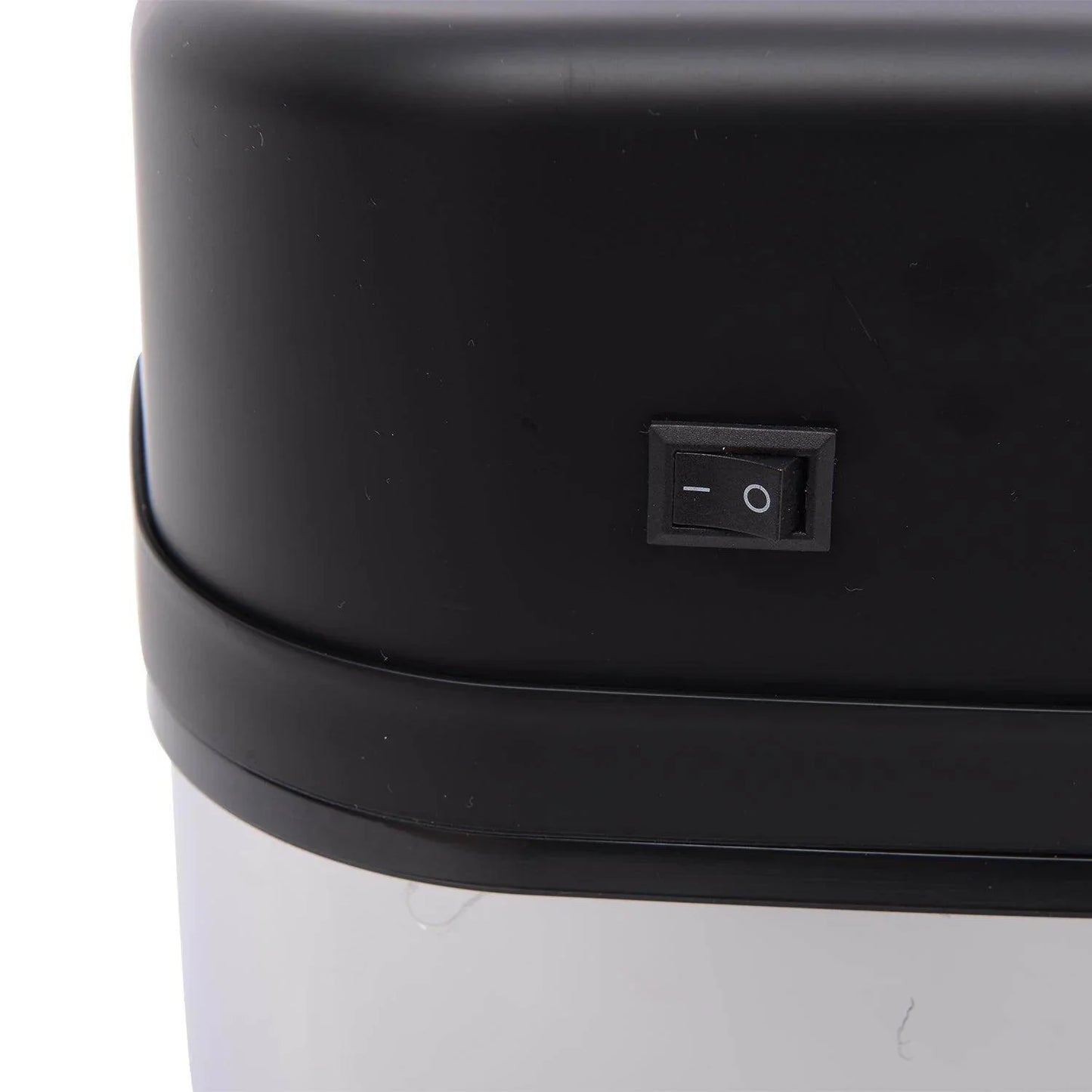 Close-up of black on/off switch on top section of modern automatic sensor dustbin