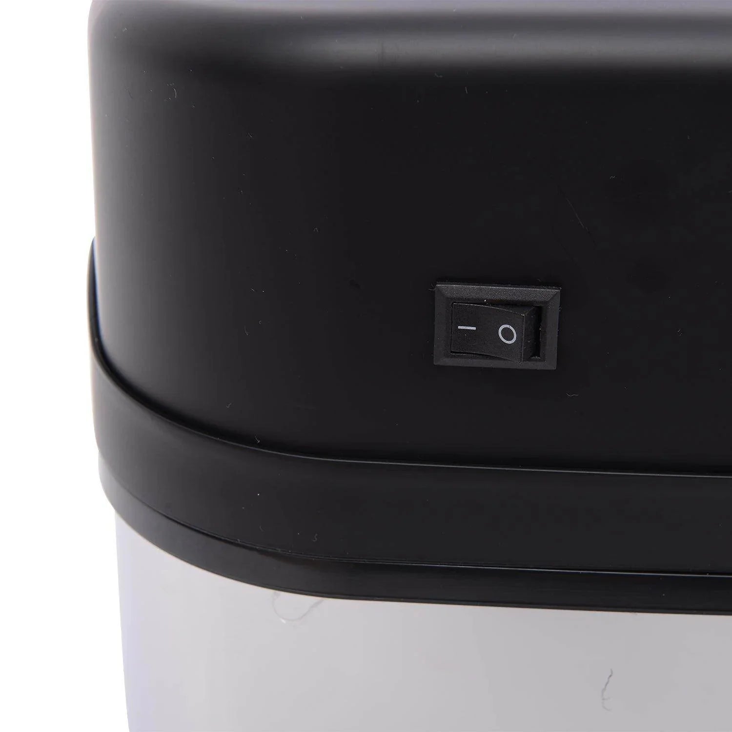 Close-up of black on/off switch on top section of modern automatic sensor dustbin