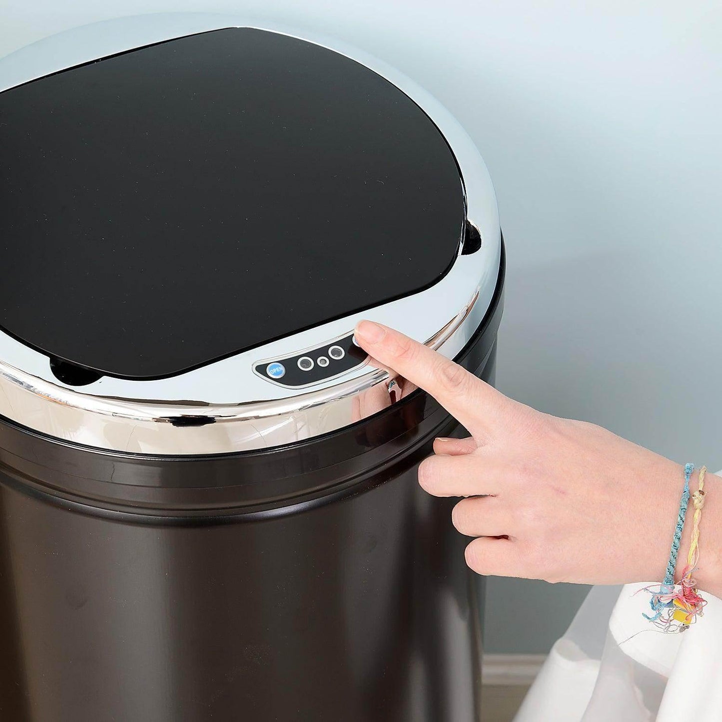 Black stainless steel sensor trash can with chrome lid and hand pressing control panel