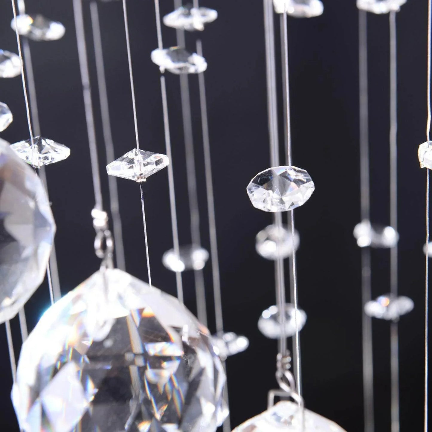 Close-up of HOMCOM spiral crystal chandelier with multiple hanging octagon crystals against dark background