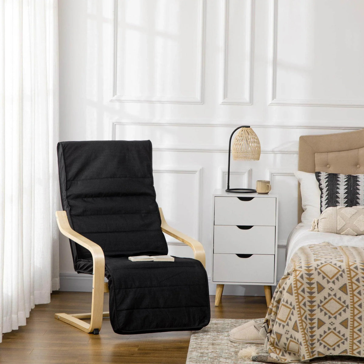 Black reclining lounge chair with attached footrest and light wood frame