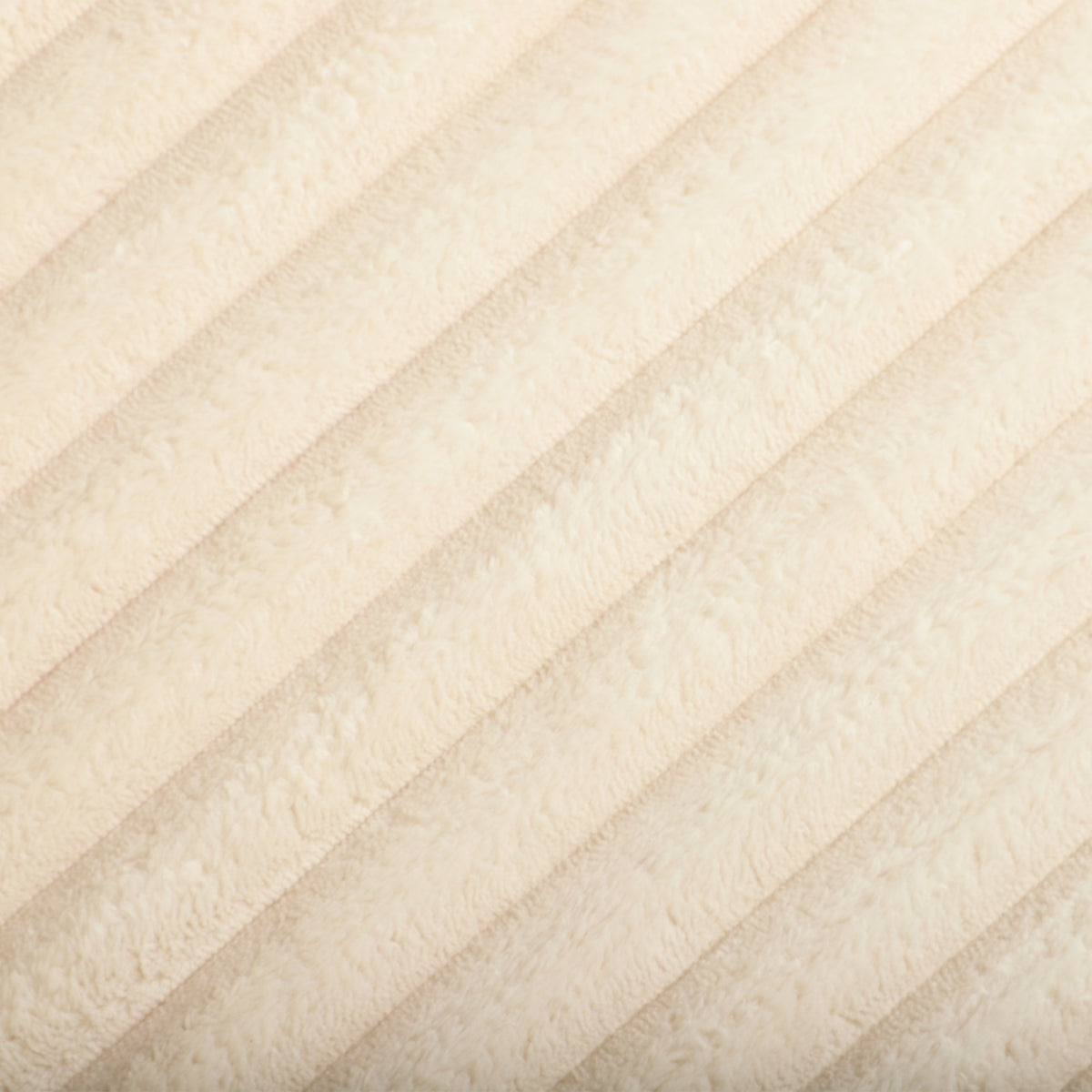 Close-up of cream corduroy fabric with ribbed vertical texture