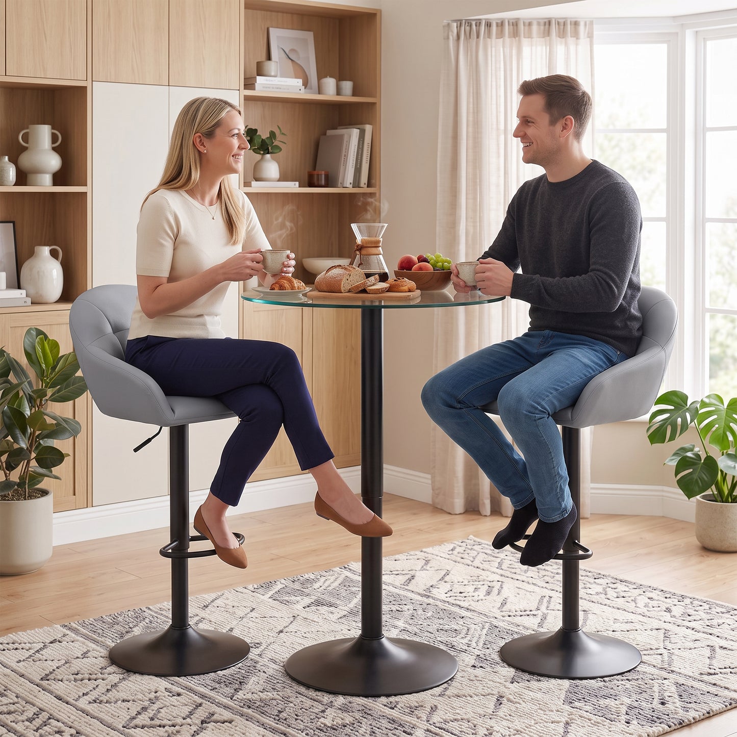 Set of two grey bar stools with padded backrest, armrests, and swivel pedestal bases