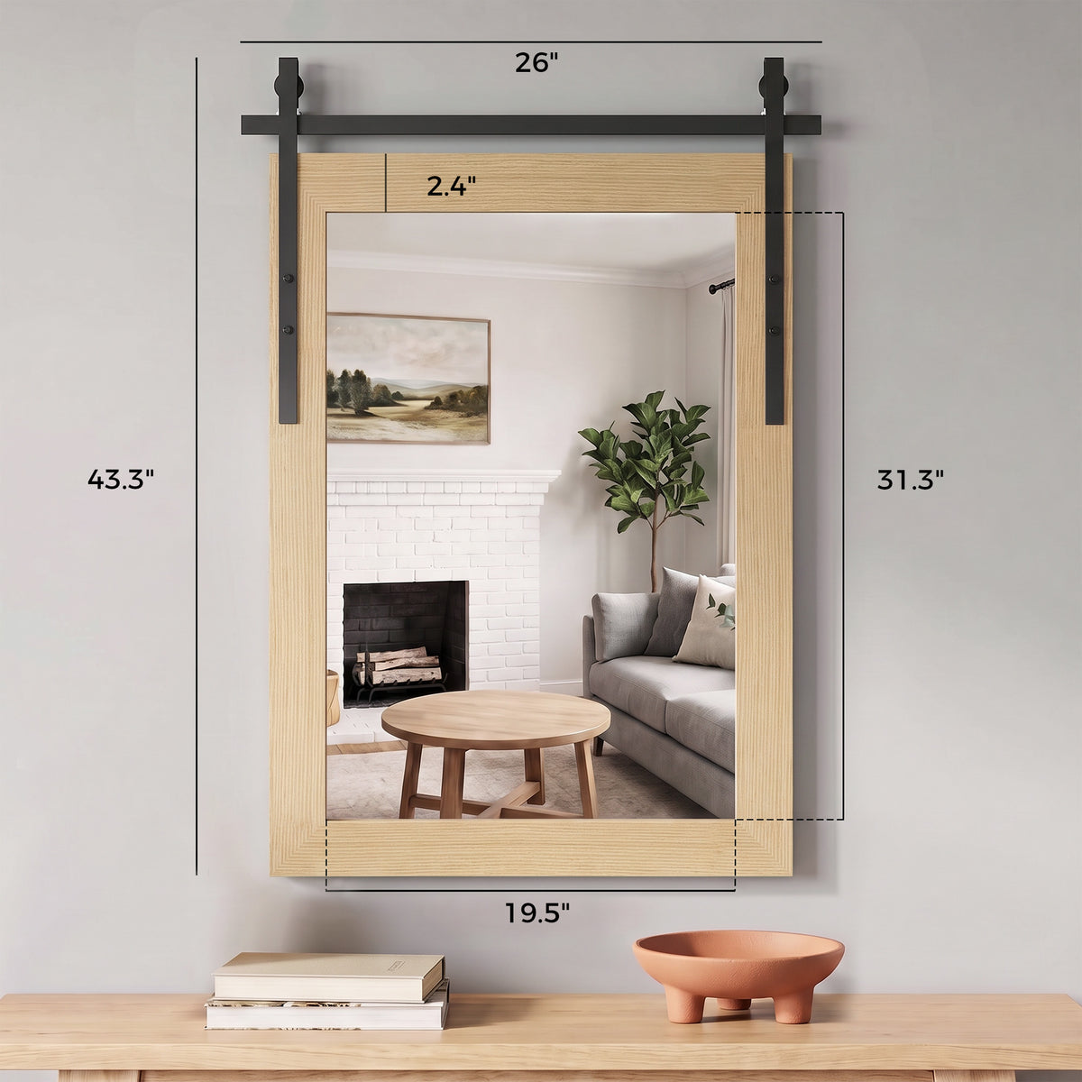 Rectangular wall mirror with light wood frame and black metal mounting hardware