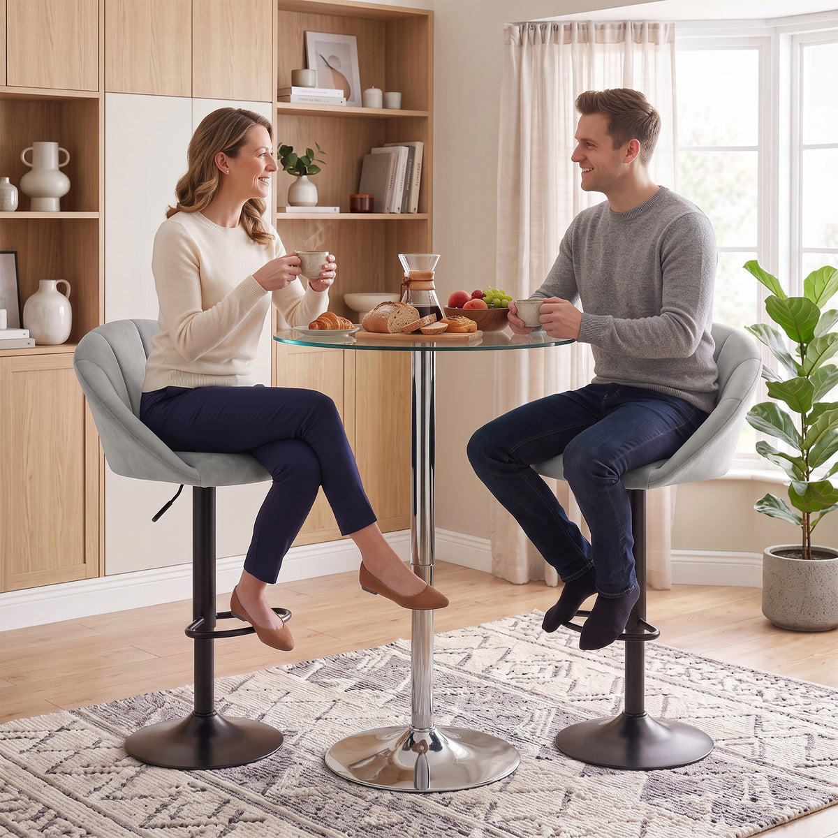Two light gray velvet counter-height stools with swivel bases and contoured seats