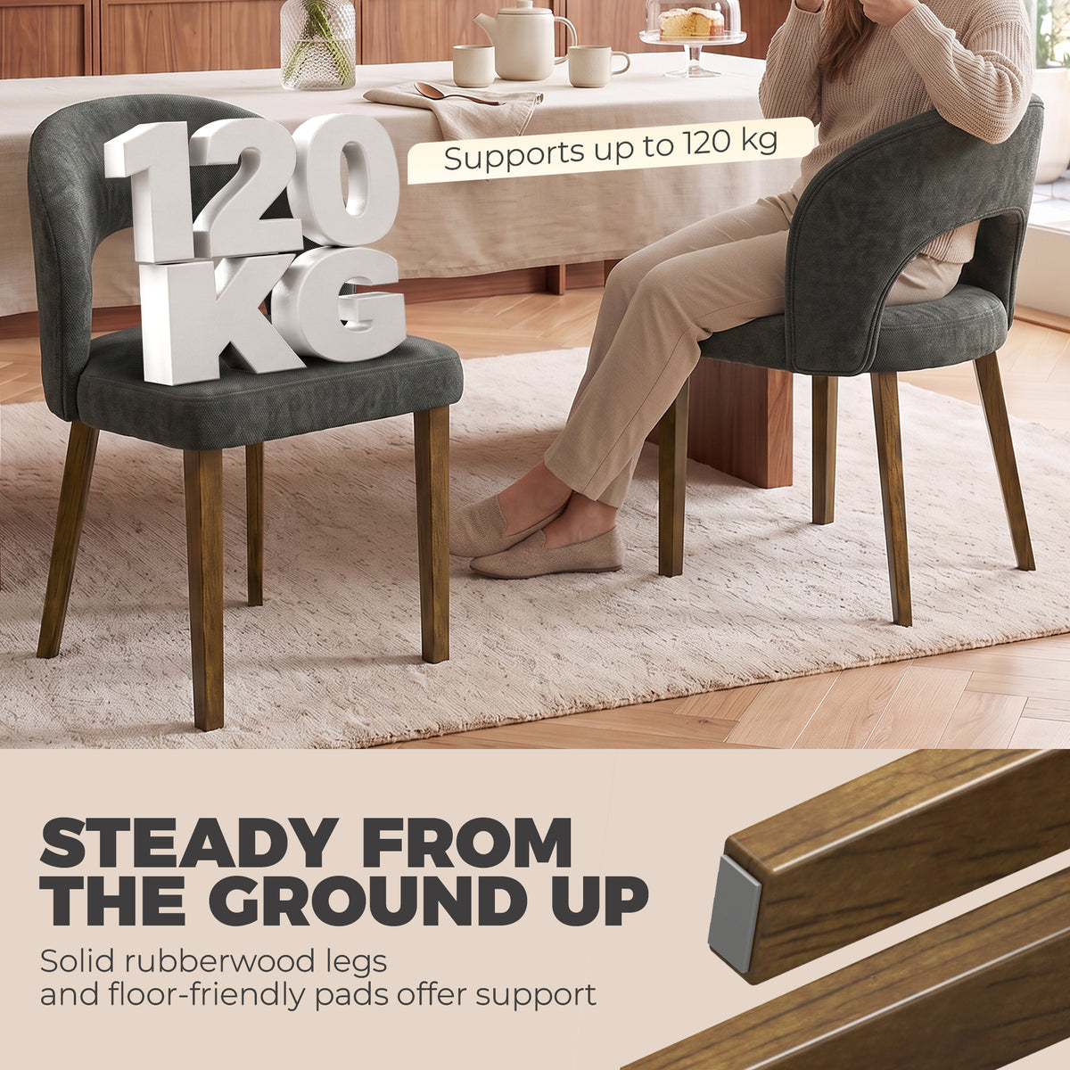Dark grey upholstered dining chair with arched backrest and wooden legs, side view