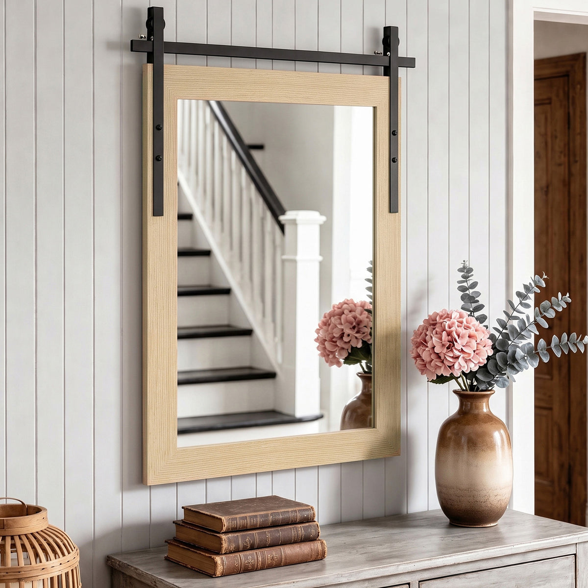Rectangular wall mirror with light wood frame and black metal corner hardware