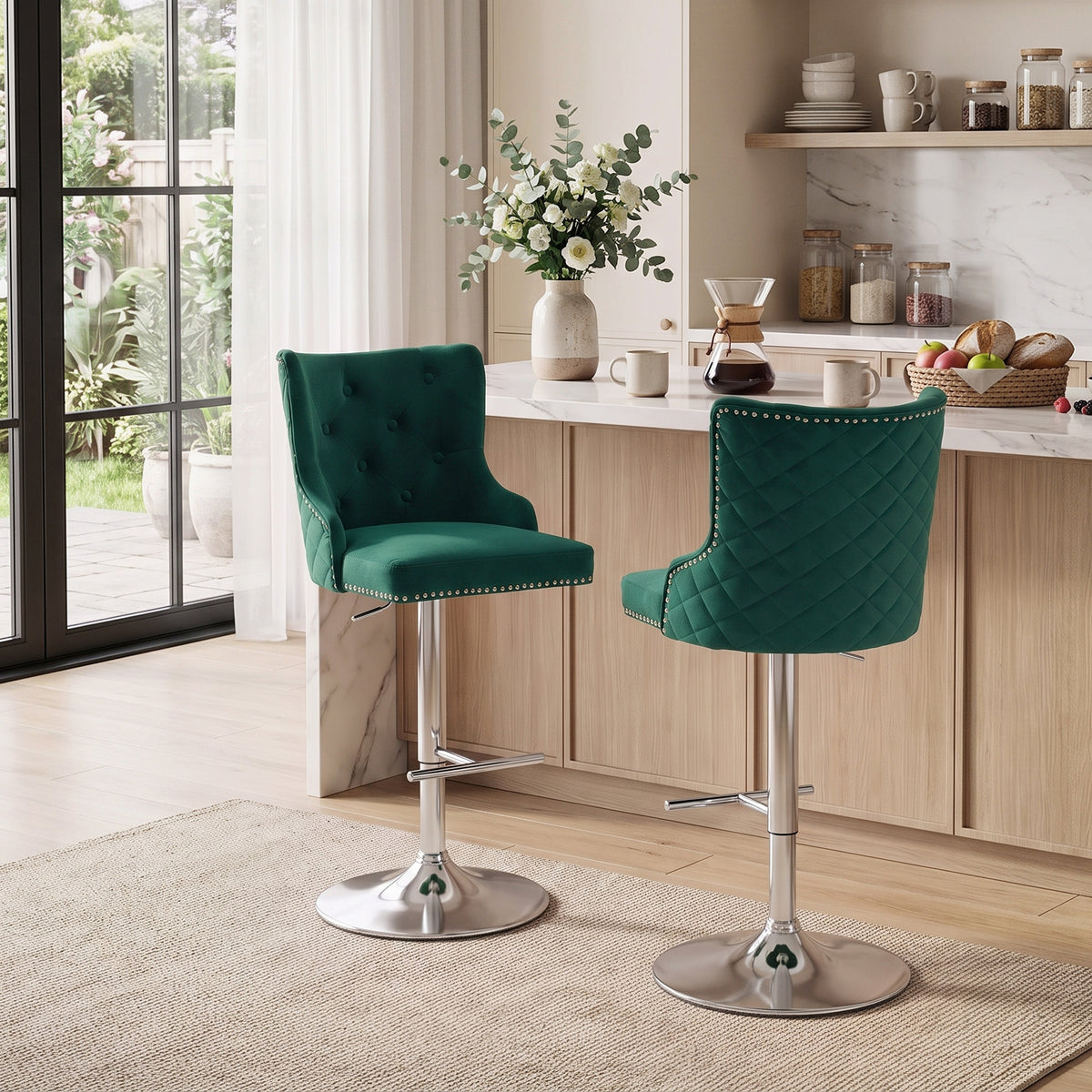 Two green velvet swivel bar stools with quilted backs, nailhead trim, and chrome pedestal bases
