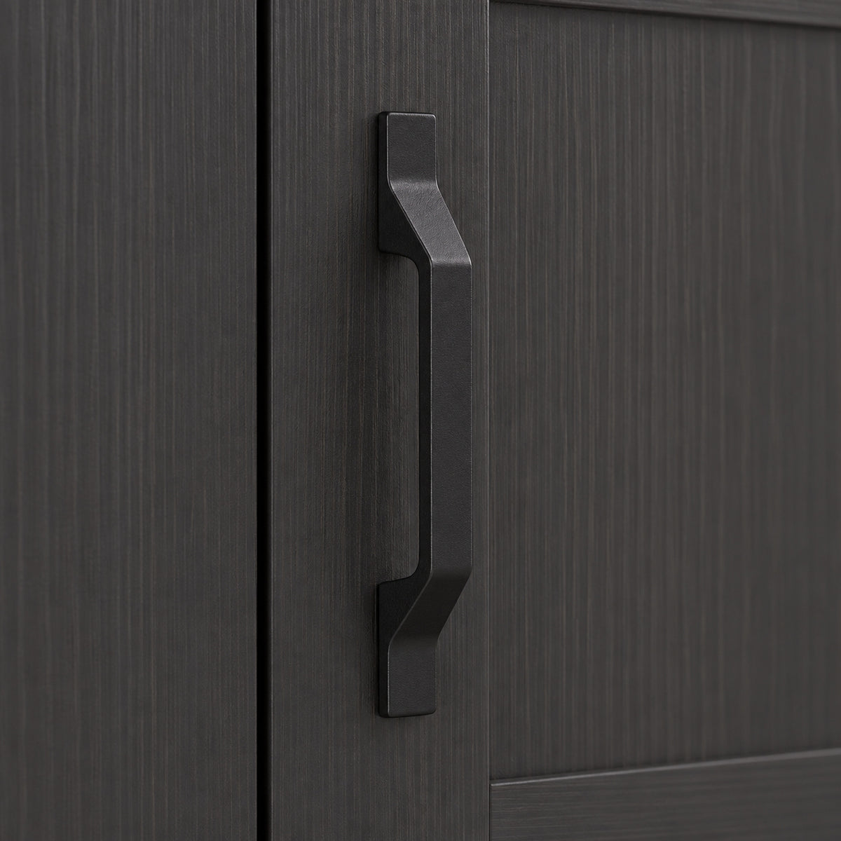 Close-up of dark gray cabinet handle on an industrial sideboard door