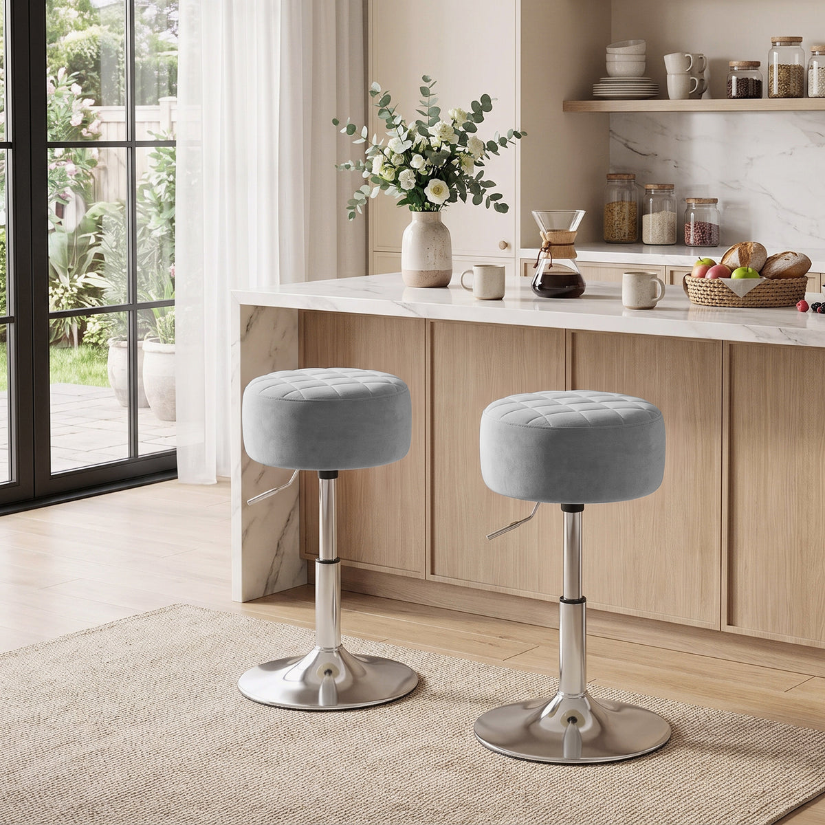 Two grey round-cushioned swivel bar stools with chrome bases in a home setting