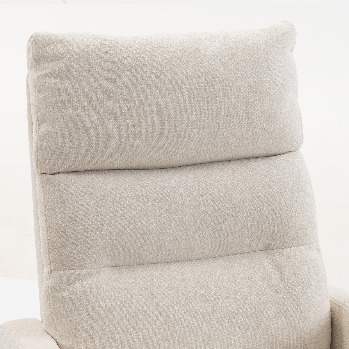 Close-up of light beige cushioned backrest on a high-back rocking chair