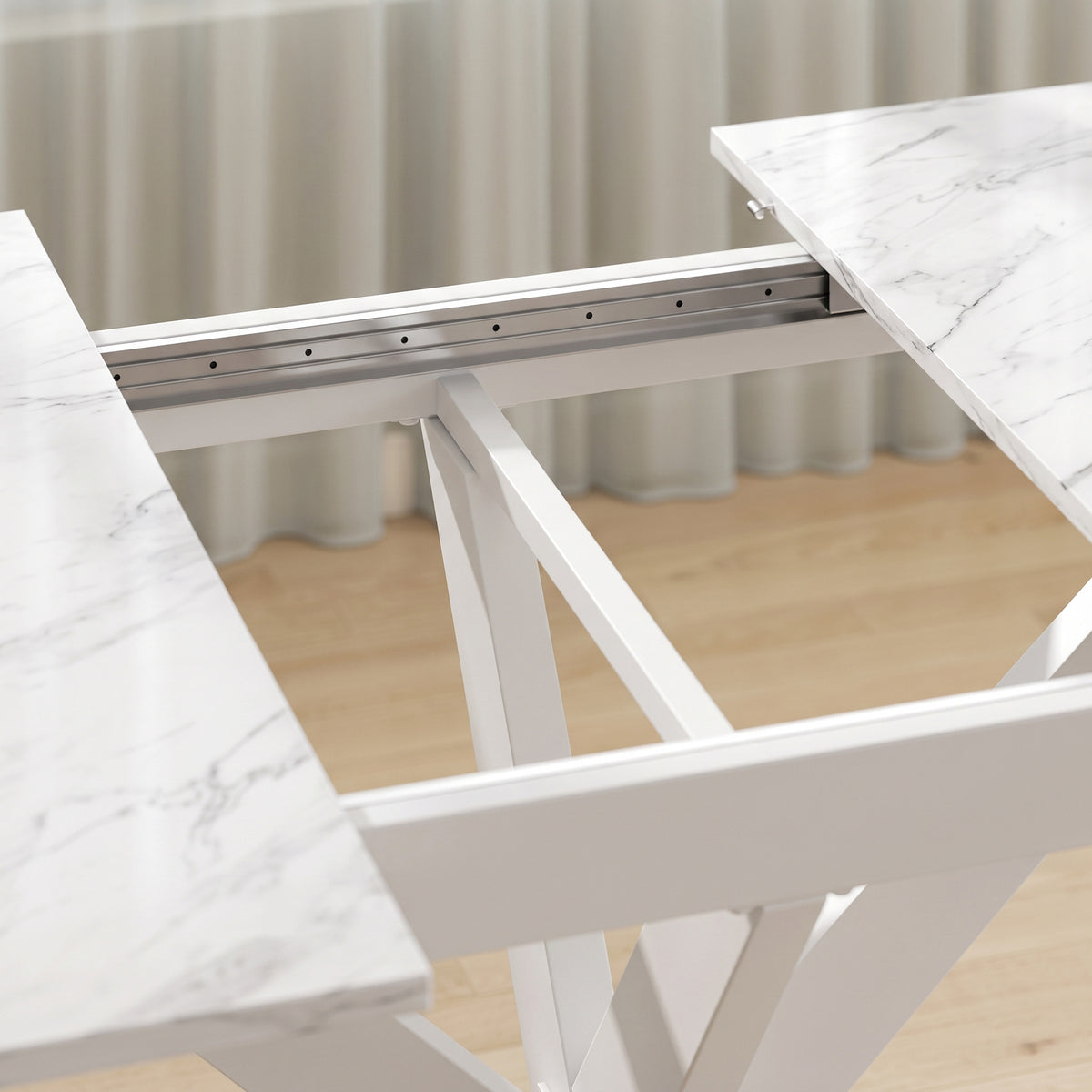 Underside view of white extendable dining table with metal support rails