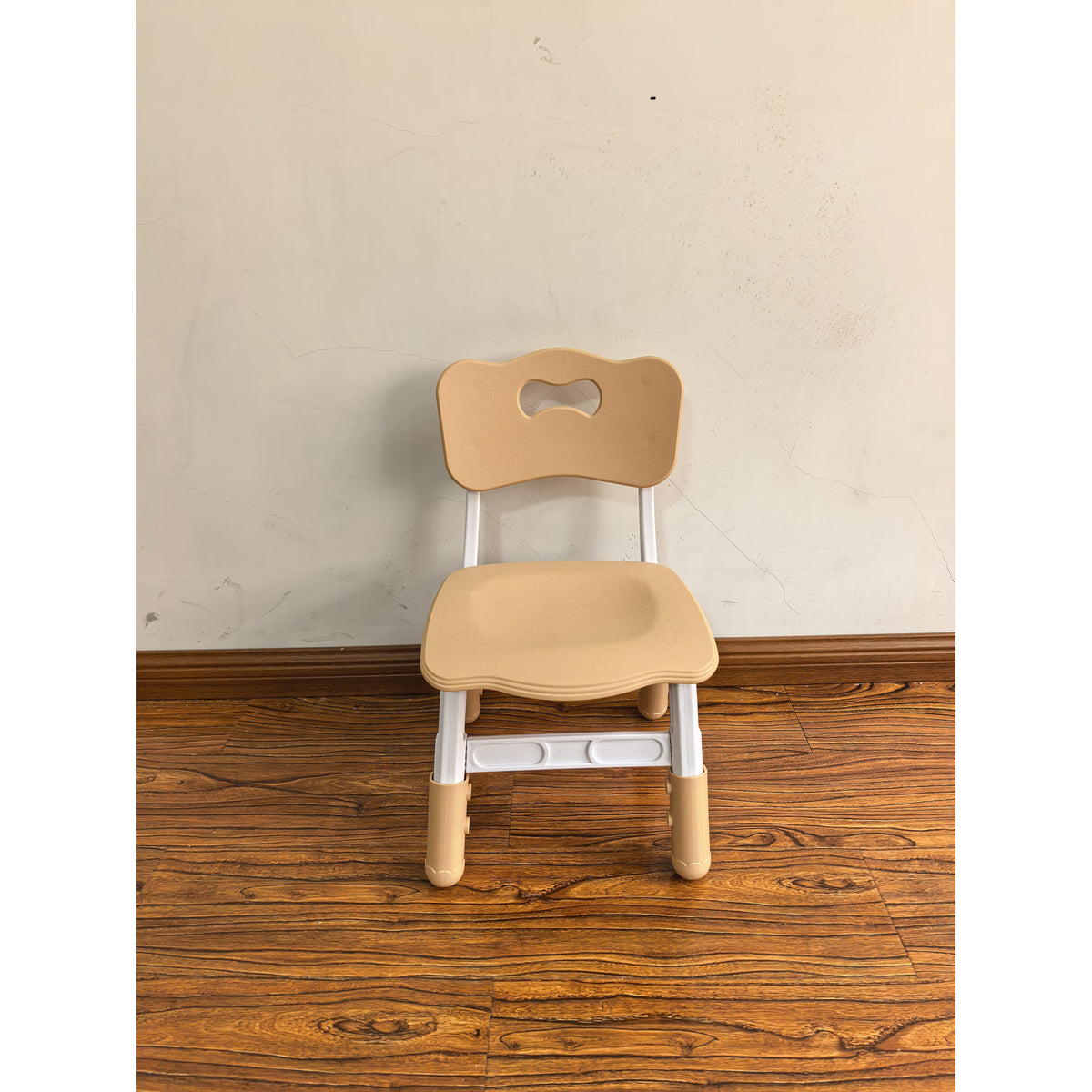 Adjustable kids desk chair with brown seat and backrest cutout, white legs