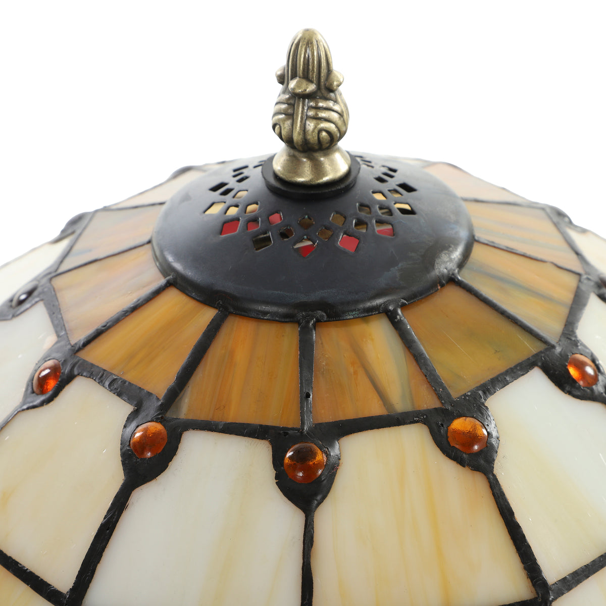 Close-up of Tiffany stained glass lamp shade with bronze top finial