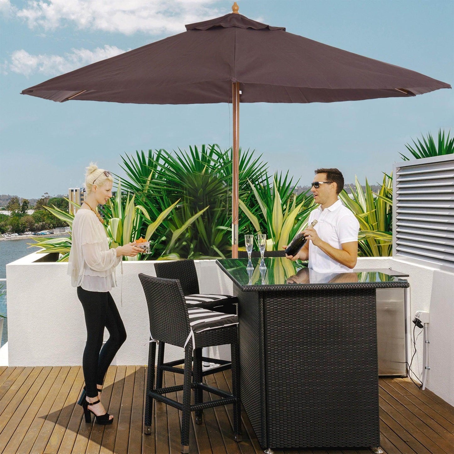 Wooden garden parasol in coffee shade beside outdoor bar set on patio, two people enjoying drinks