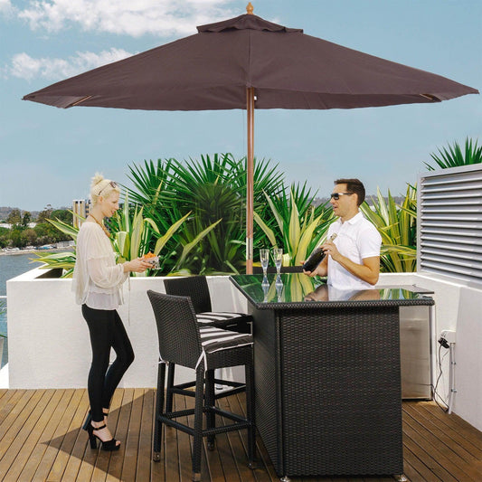 Outdoor rooftop patio with black wicker bar table, high chairs, large brown wooden garden parasol, and two people socializing