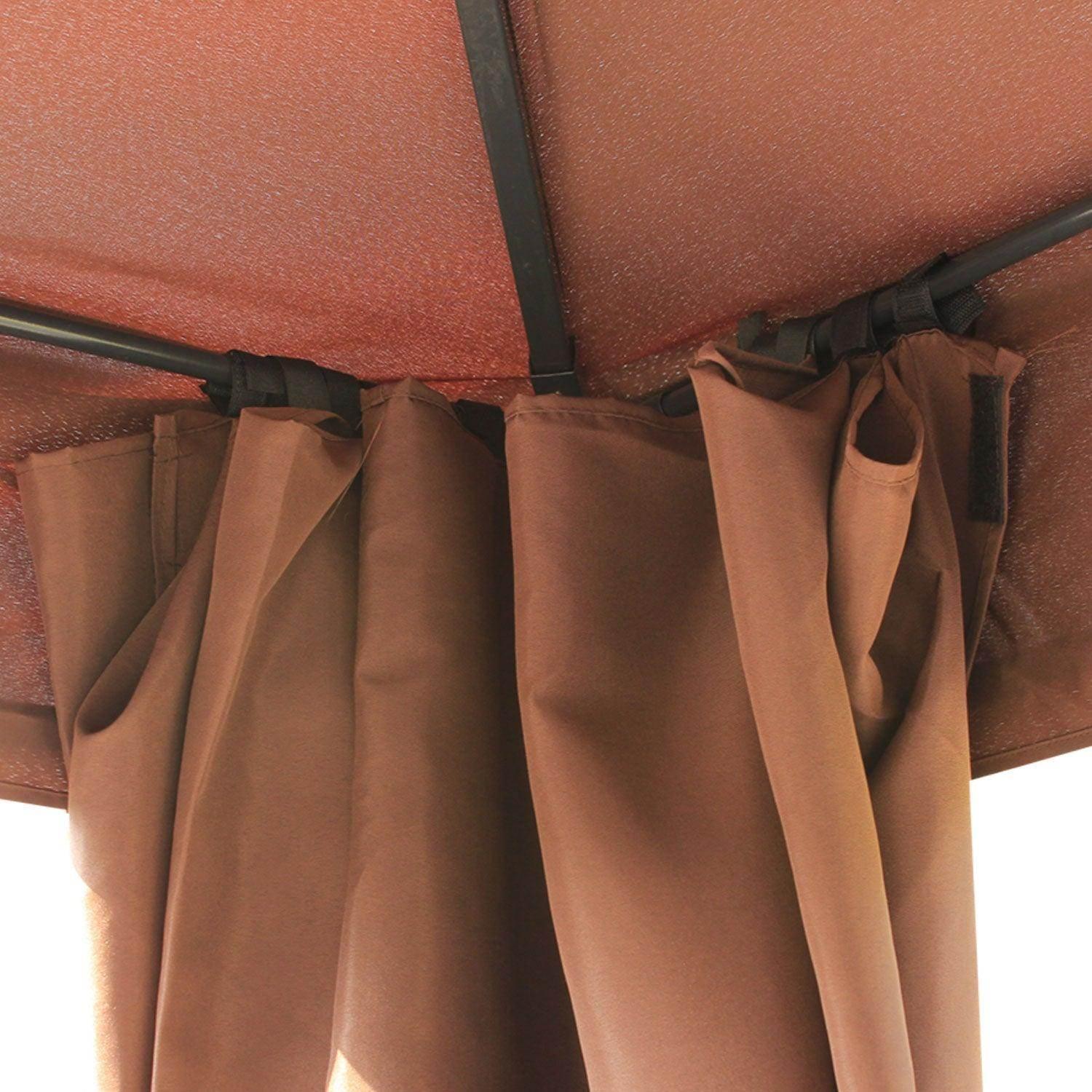 Close-up of brown fabric sidewalls attached with straps inside a metal gazebo roof, outdoor garden shelter