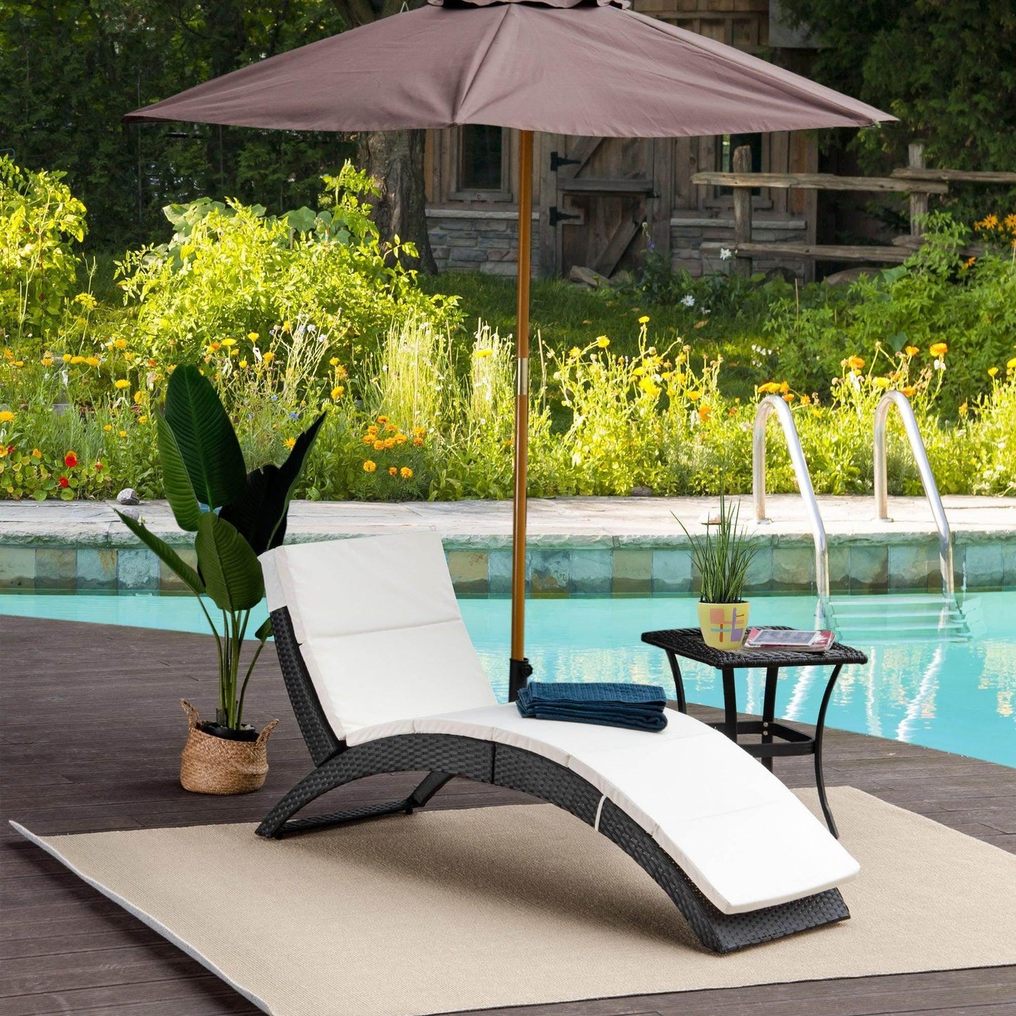 Black rattan sun lounger with white cushion by poolside, under umbrella, ALL4U RETAILER LTD
