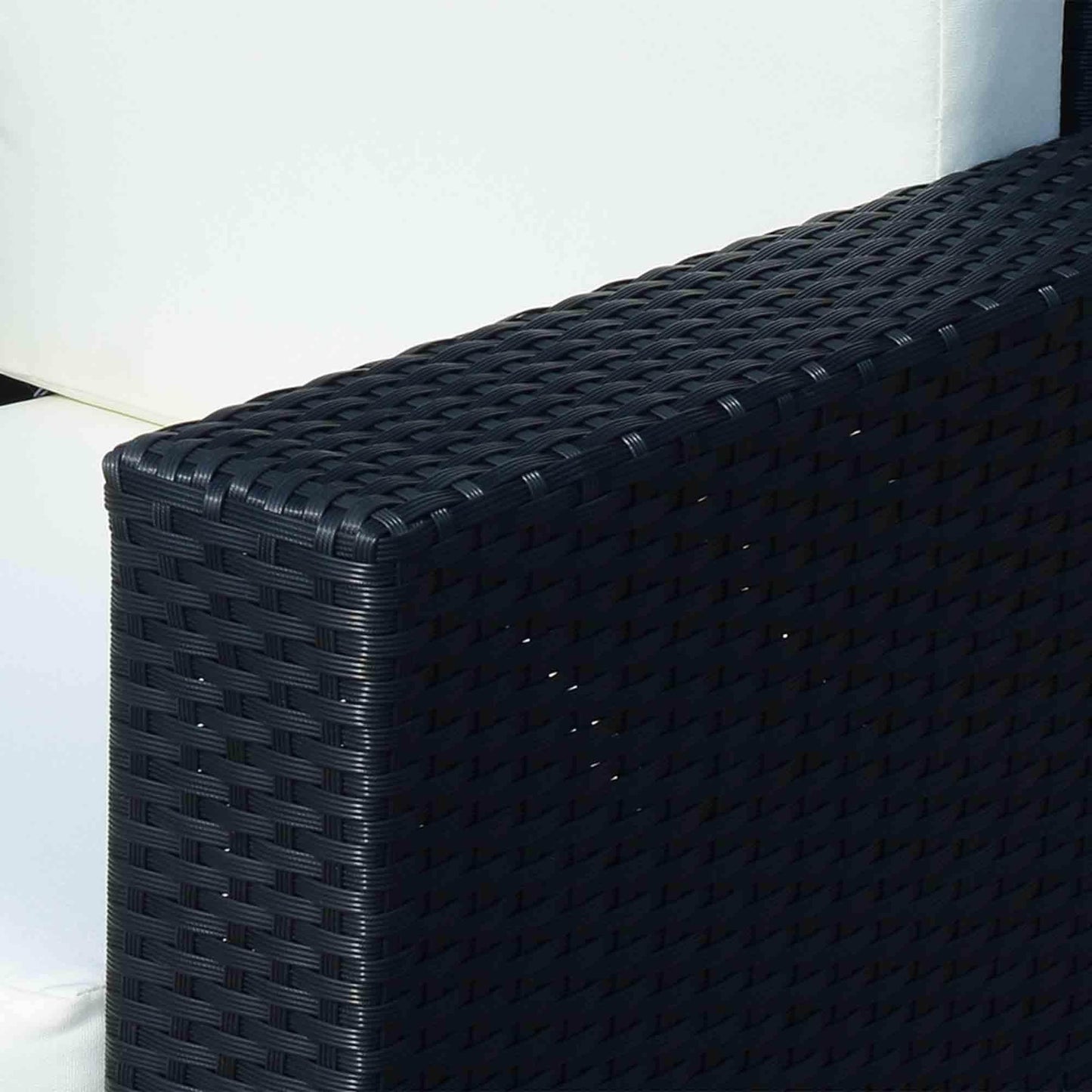 Close-up of black woven rattan armrest with white cushion on outdoor single sofa chair