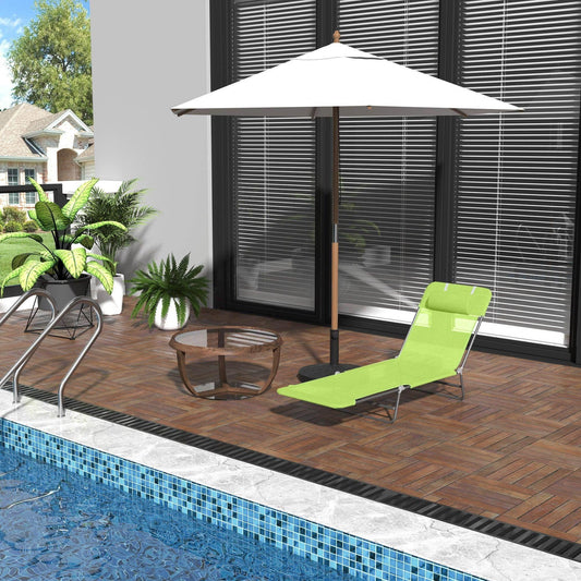 Green outdoor lounger with white patio umbrella by poolside on wooden deck with glass table and potted plants