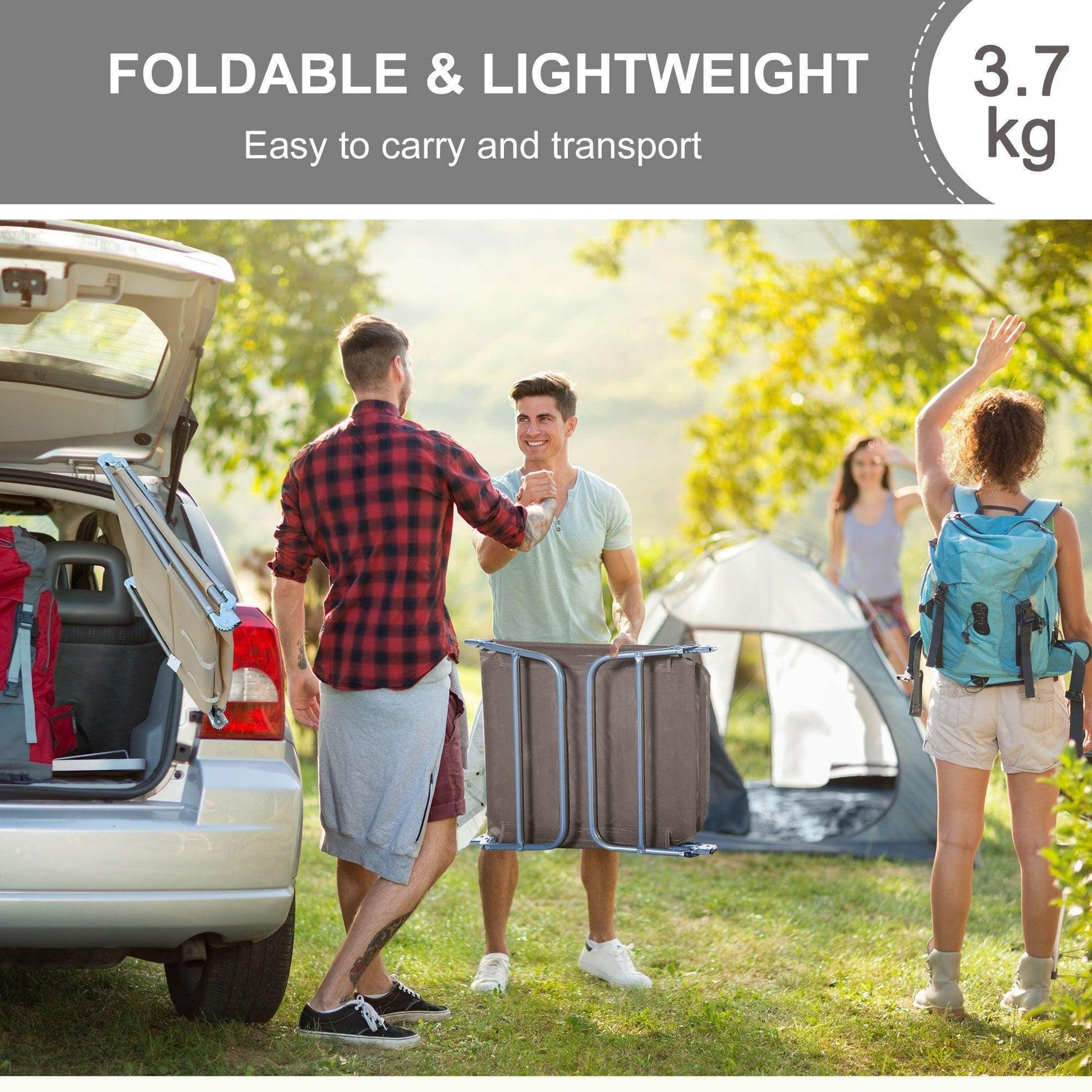 Two men with foldable lightweight outdoor furniture near car and tent in green camping setting