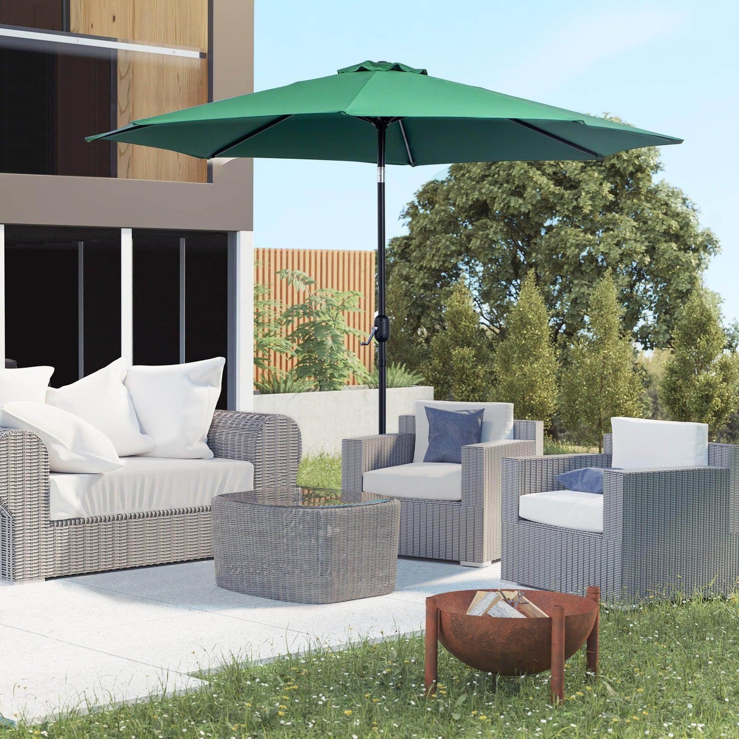 Green tilting outdoor sun umbrella with crank handle, open canopy over patio seating
