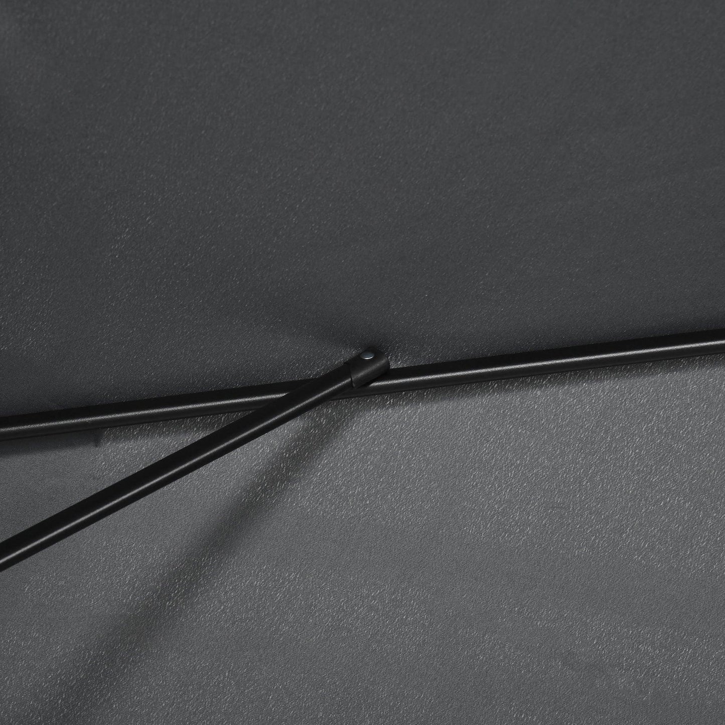 Close-up of black patio umbrella fabric with stitched seam and support bar