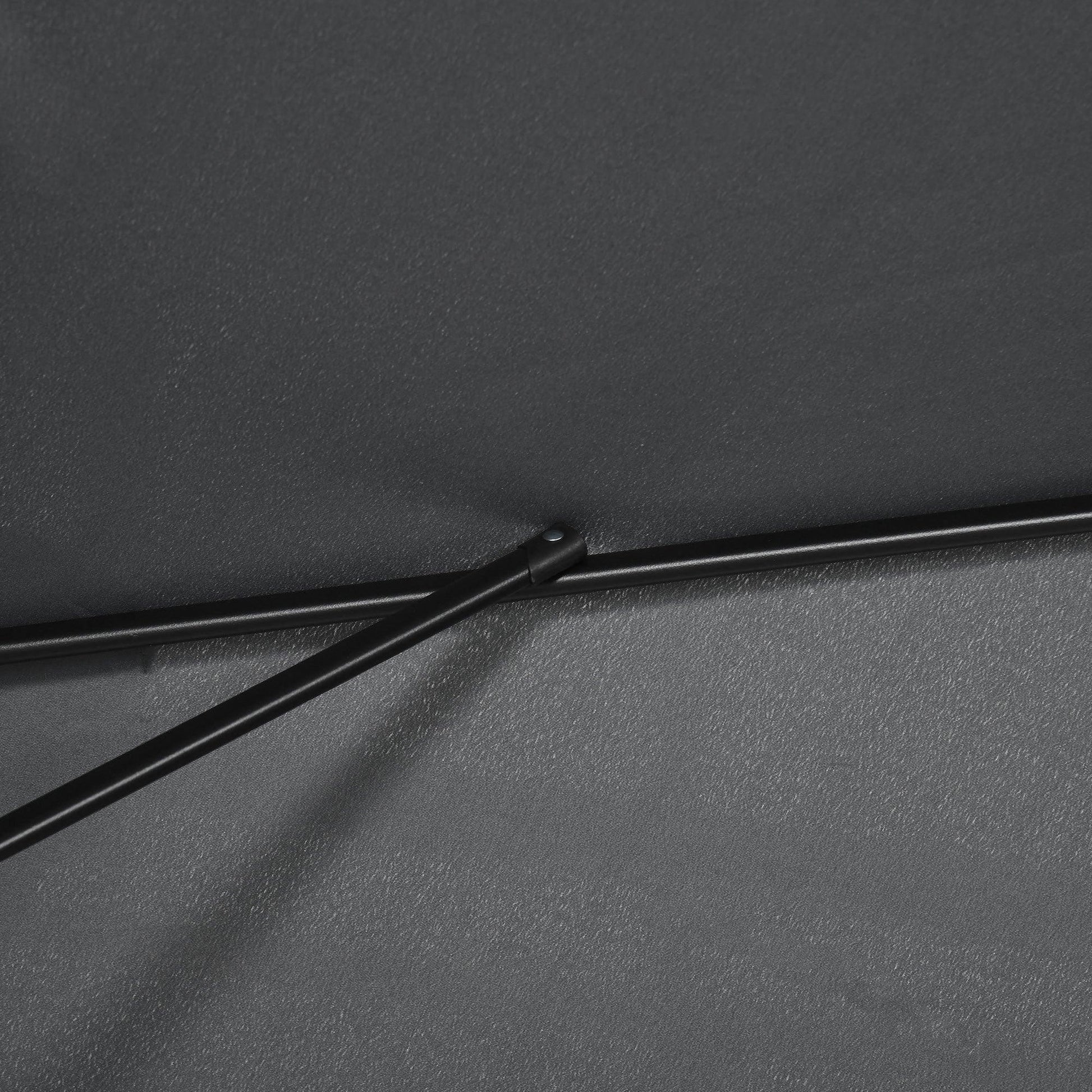 Close-up of black patio umbrella fabric with stitched seam and support bar