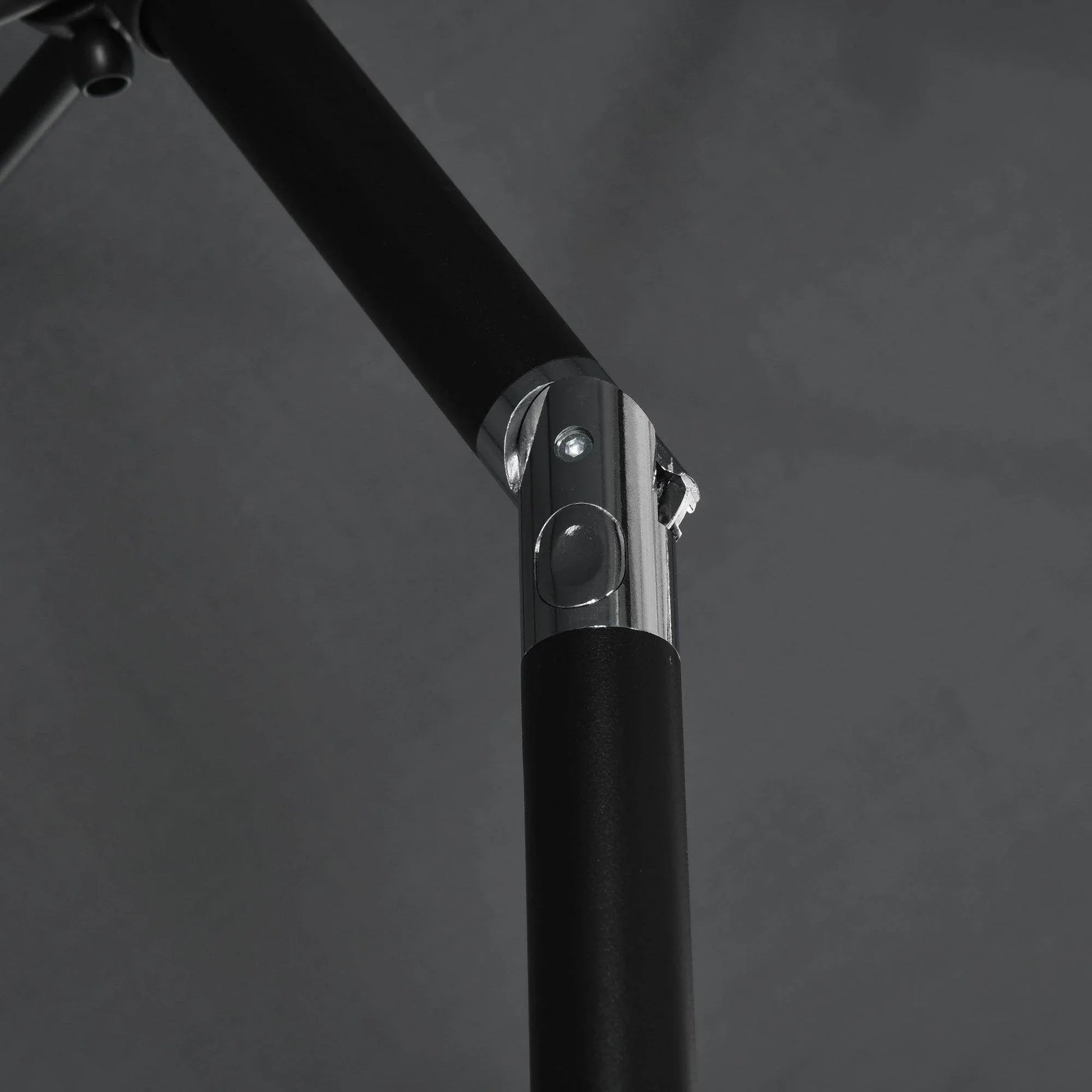 Close-up of black tilt crank base on rectangular patio umbrella center pole