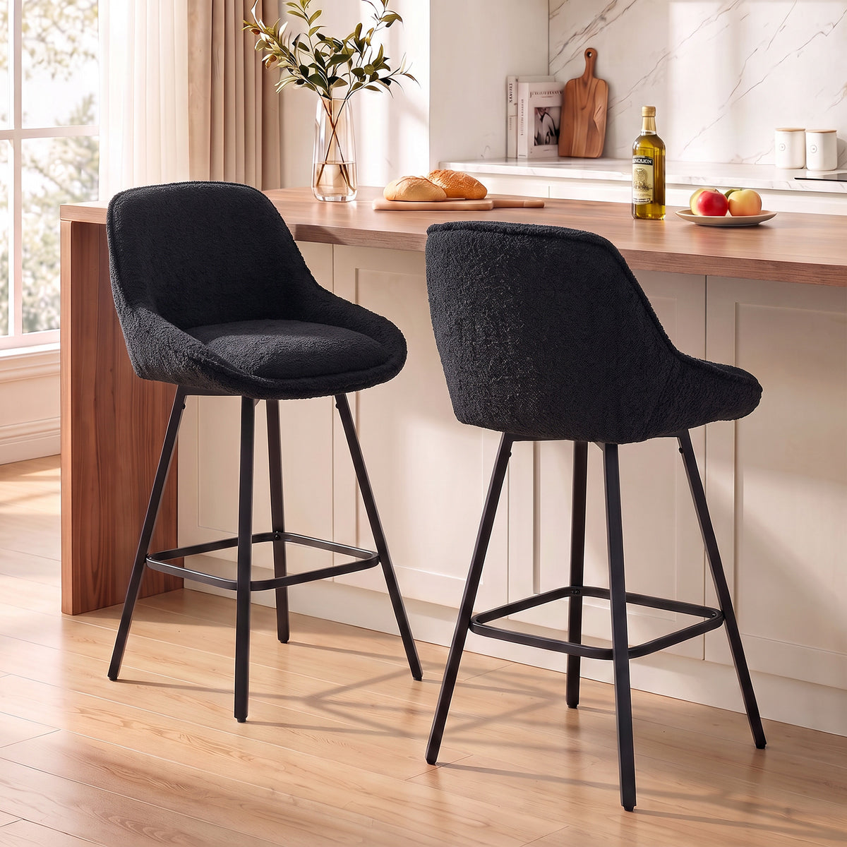 Pair of black swivel bar stools with curved seats, tall backs, and metal footrest frames