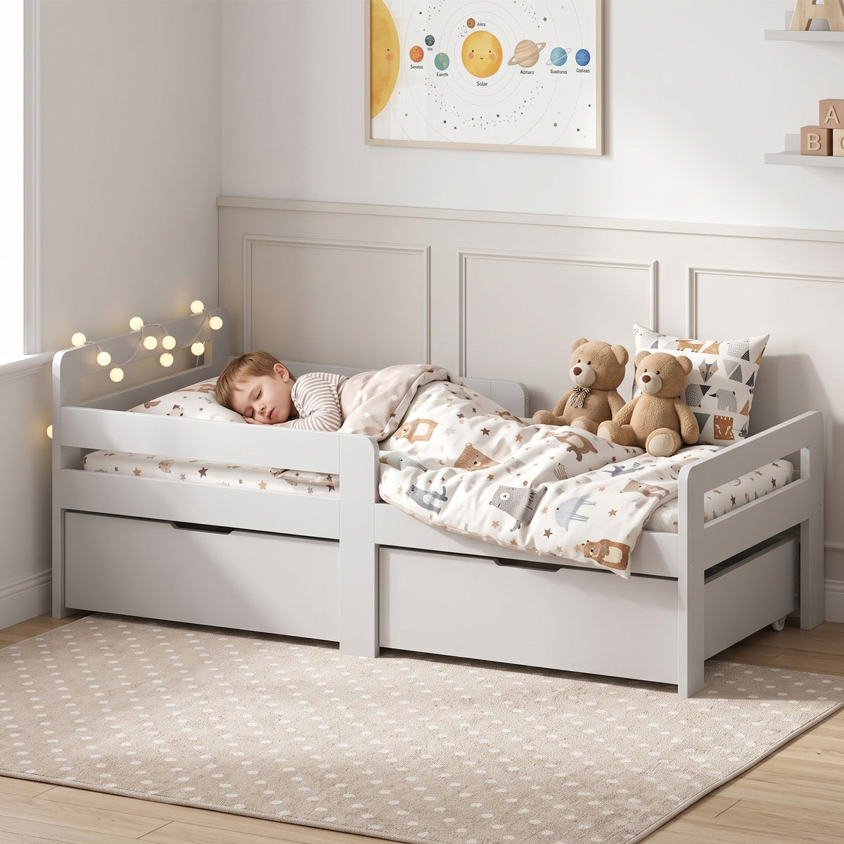 Light grey wooden kids bed with guard rails and two under-bed storage drawers, cozy bedding