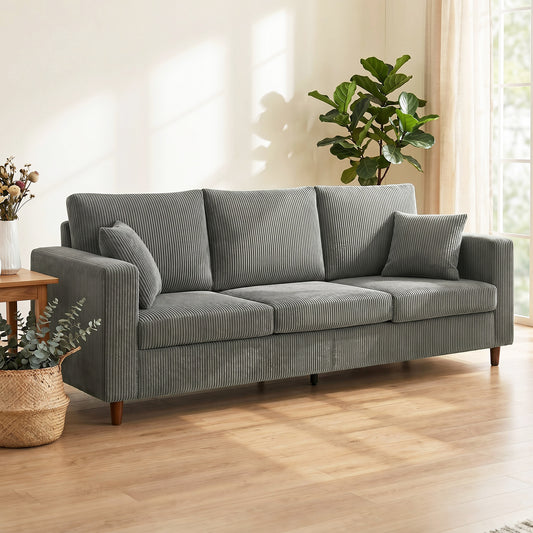 Light grey corduroy three-seat sofa with wide deep seat and supportive arms