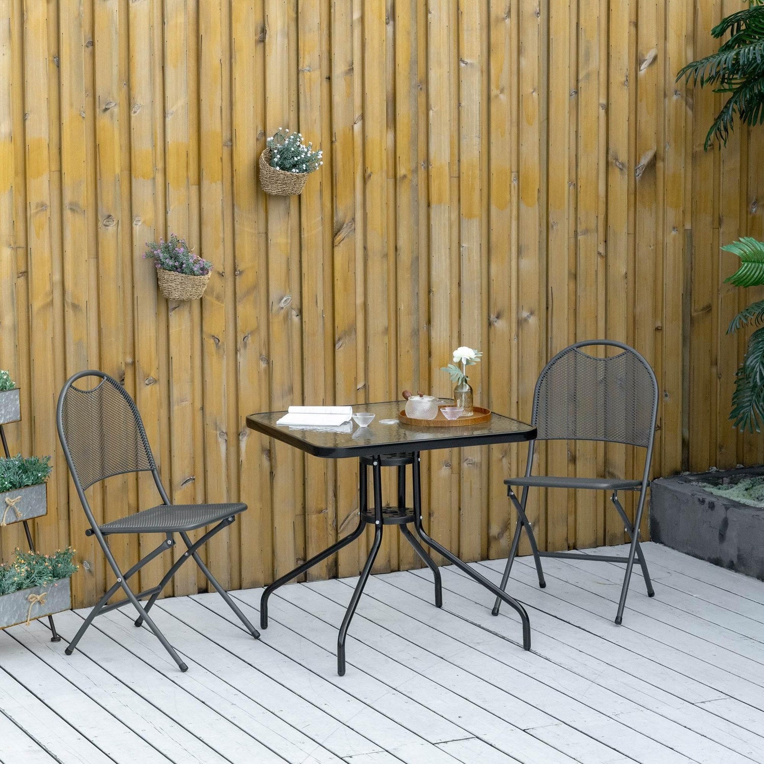 Square outdoor bistro table with dark steel frame and clear tempered glass top