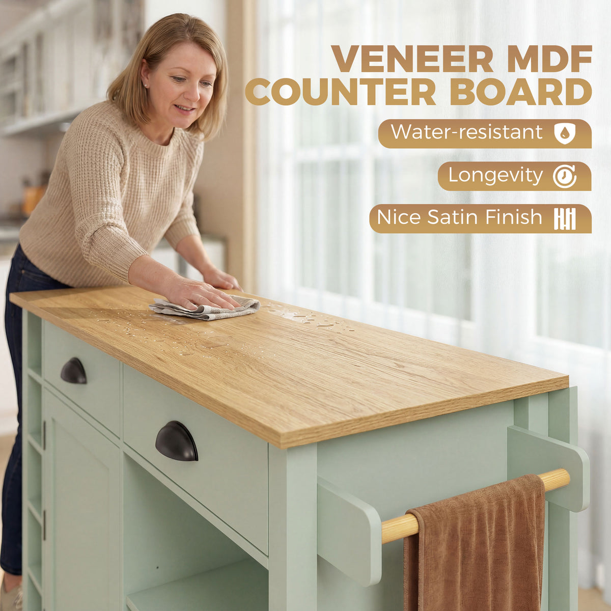 Light green kitchen island with wood countertop, drawer fronts, and towel bar