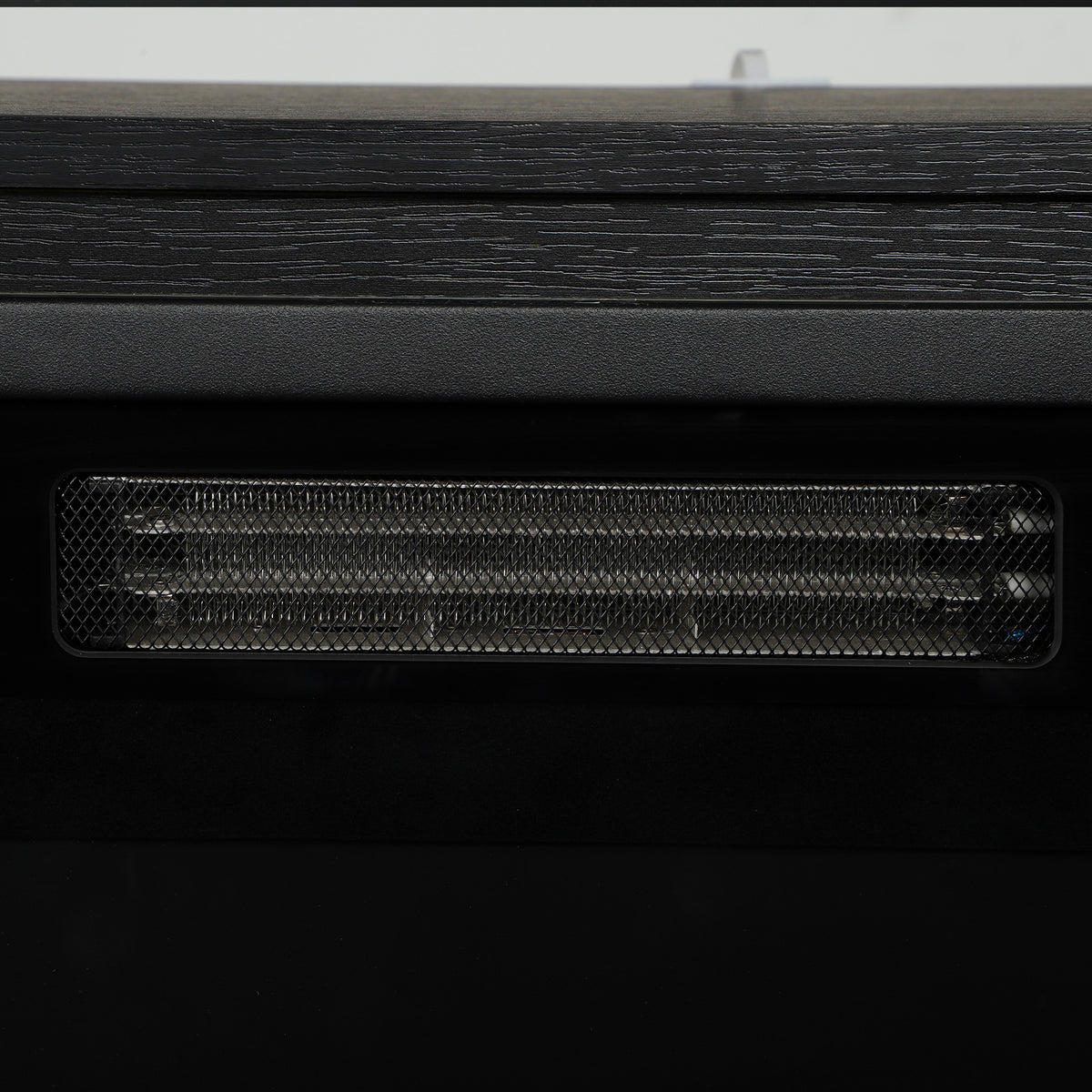 Electric heater vent grille on heated TV stand fireplace insert