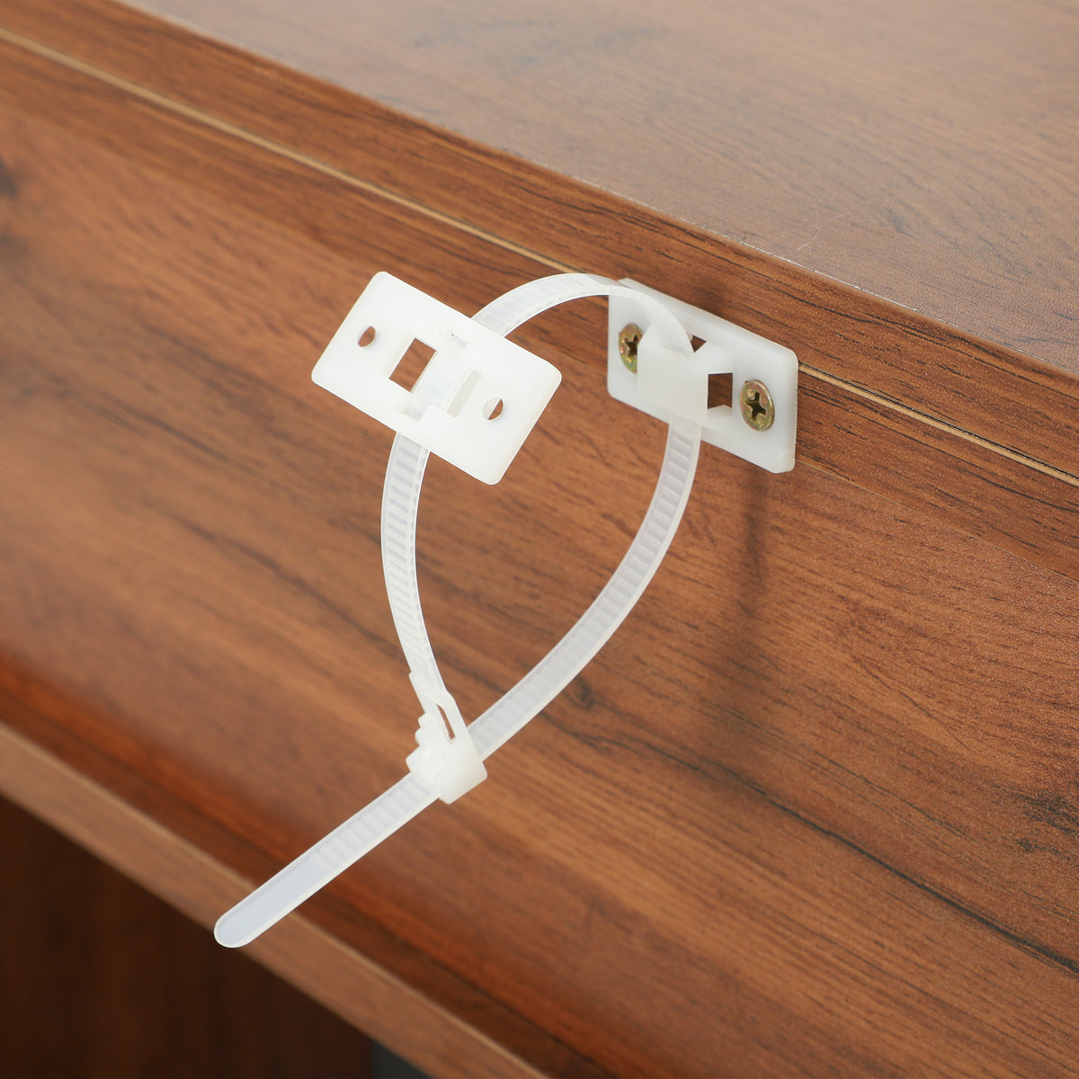 Electric fireplace TV stand power cord with white plug on wood tabletop