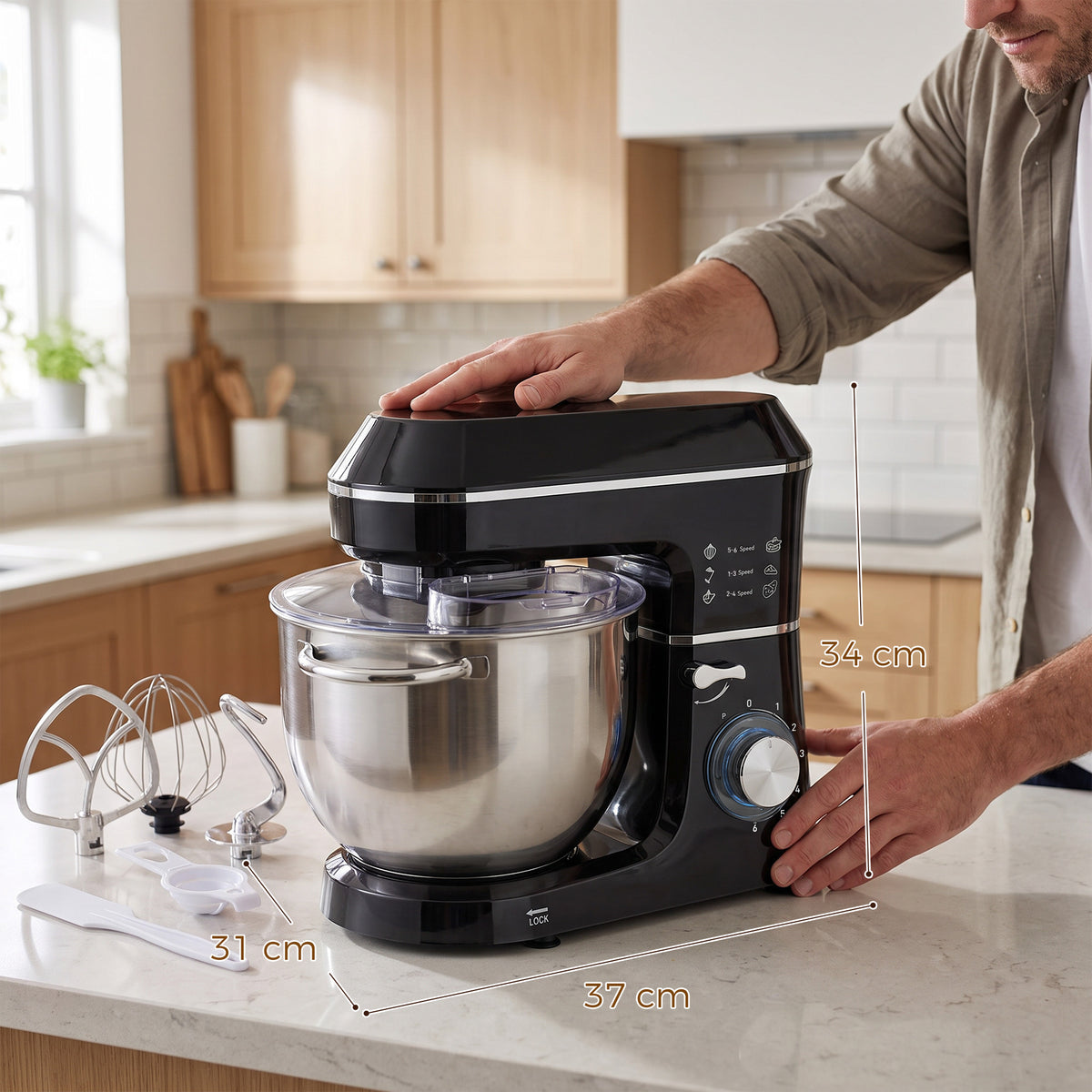 Black stand mixer on countertop with stainless bowl as user turns the speed dial