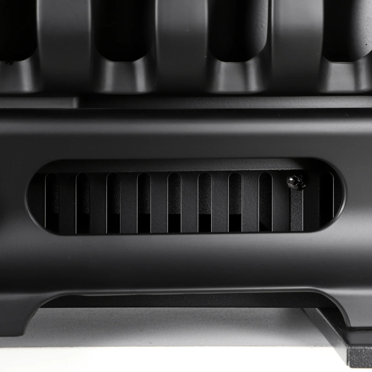 Close-up of electric fireplace air vent and firebox base grille
