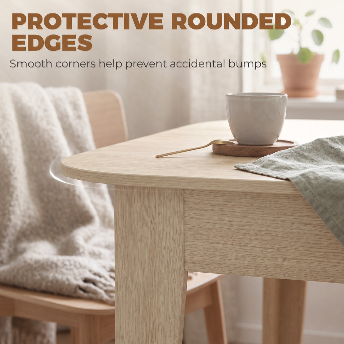 Light oak oval dining table with rounded edge and coffee cup on top